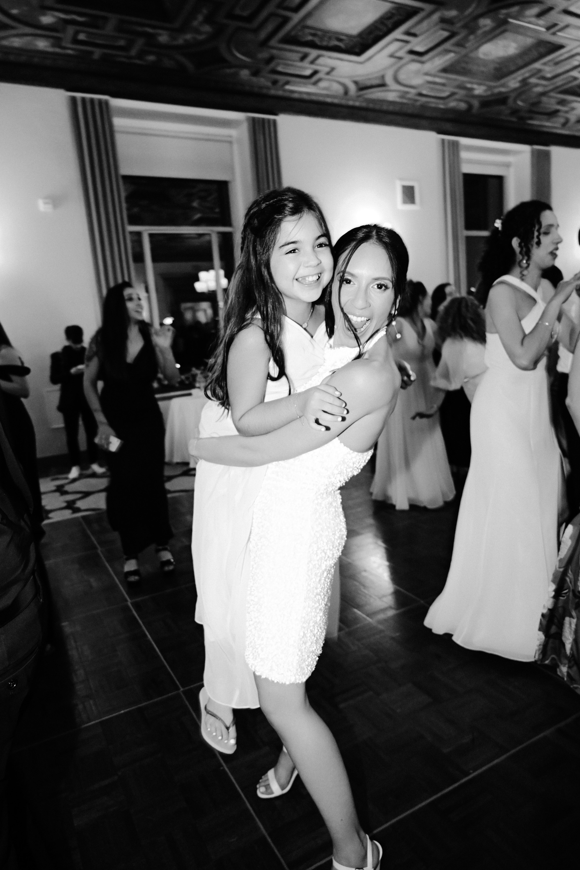 a bride and her daughter dancing at a wedding reception