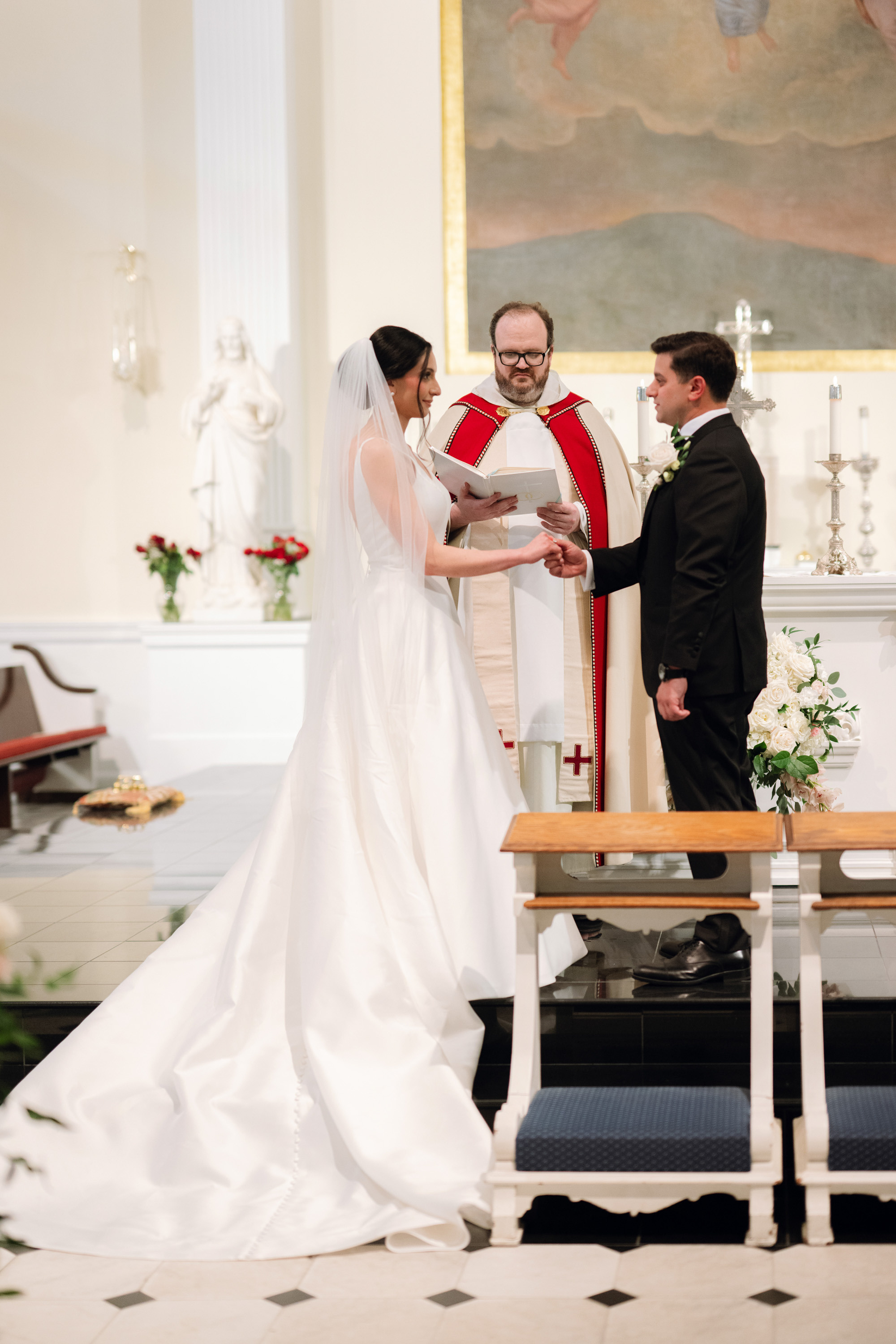 a man and woman are standing at the alter