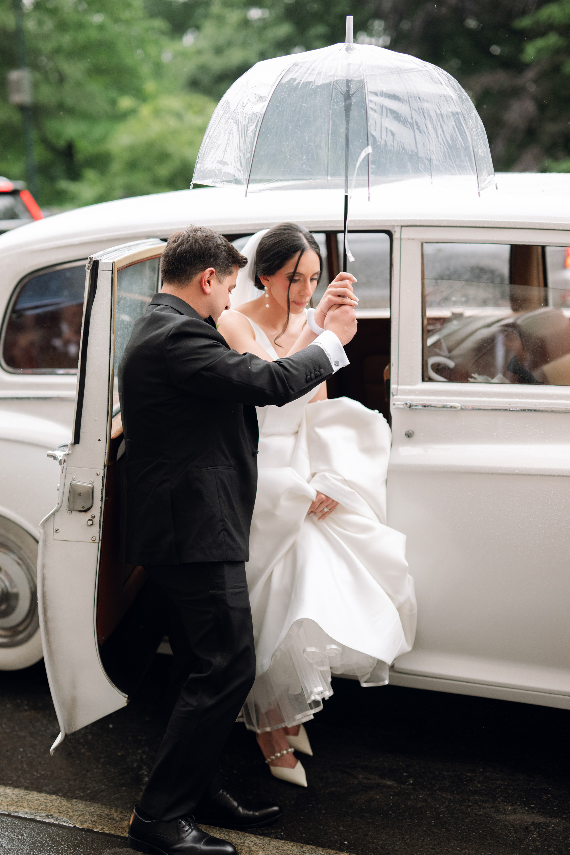a bride and groom are getting into a vintage car
