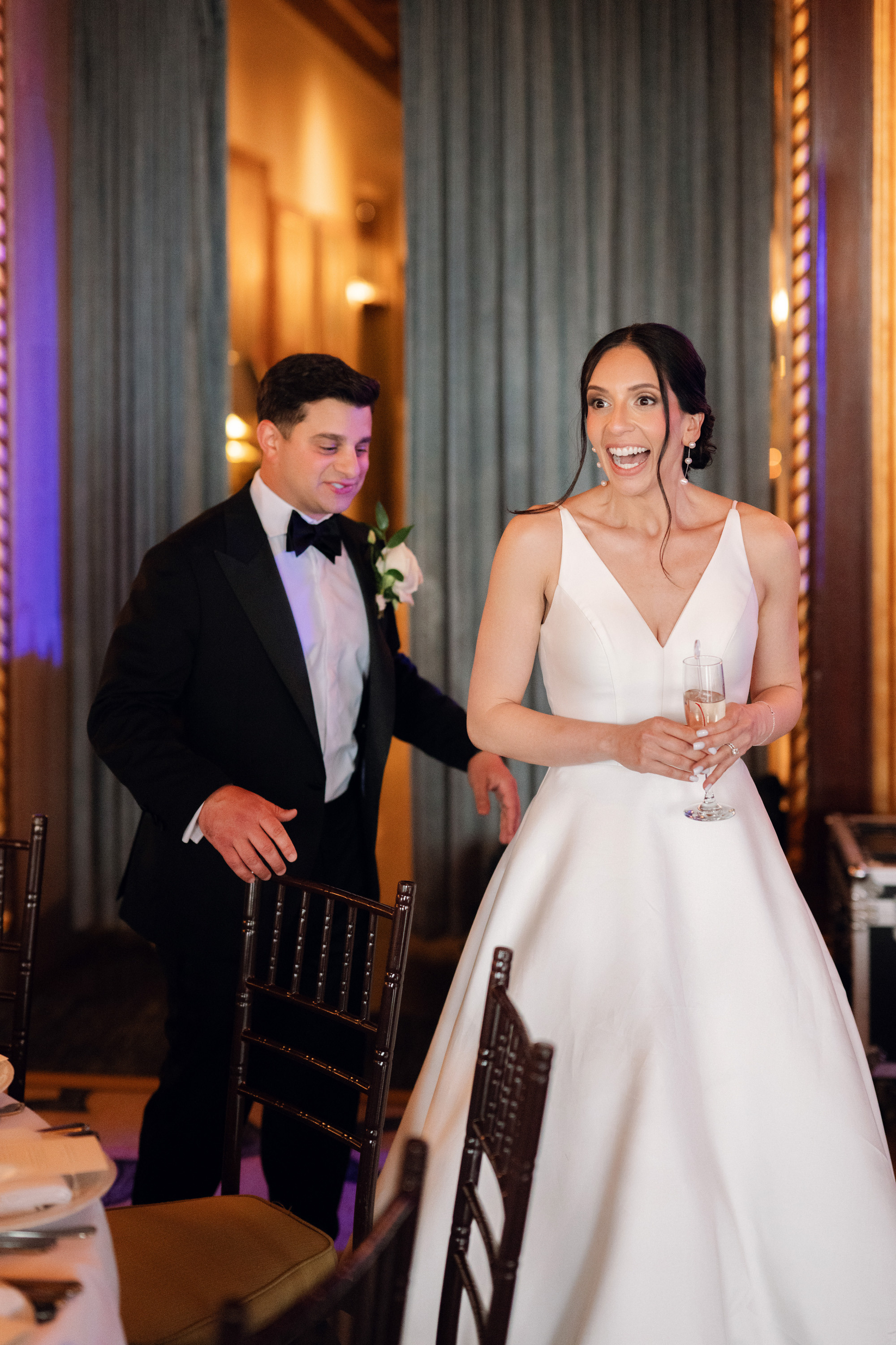a bride and groom are standing in a room