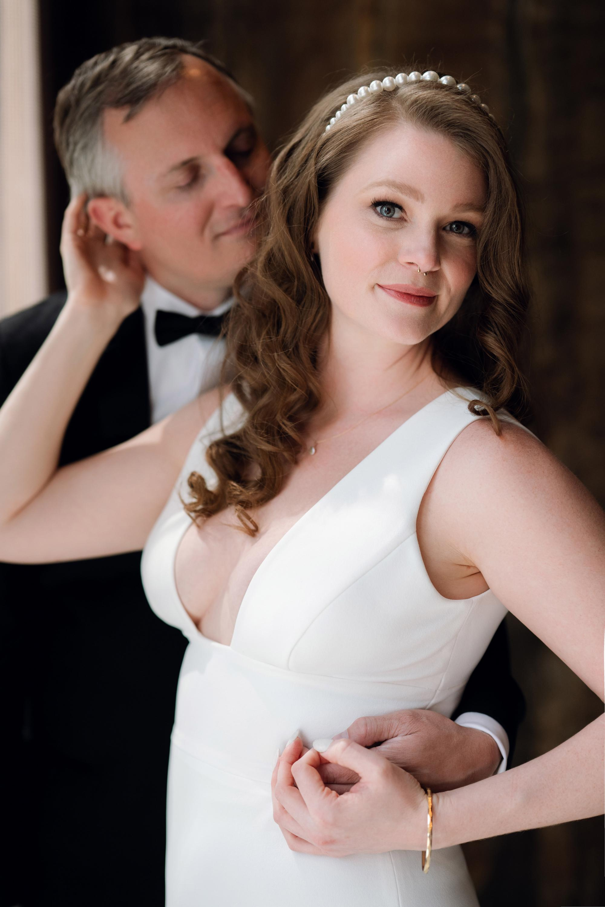 a bride and groom pose for a photo