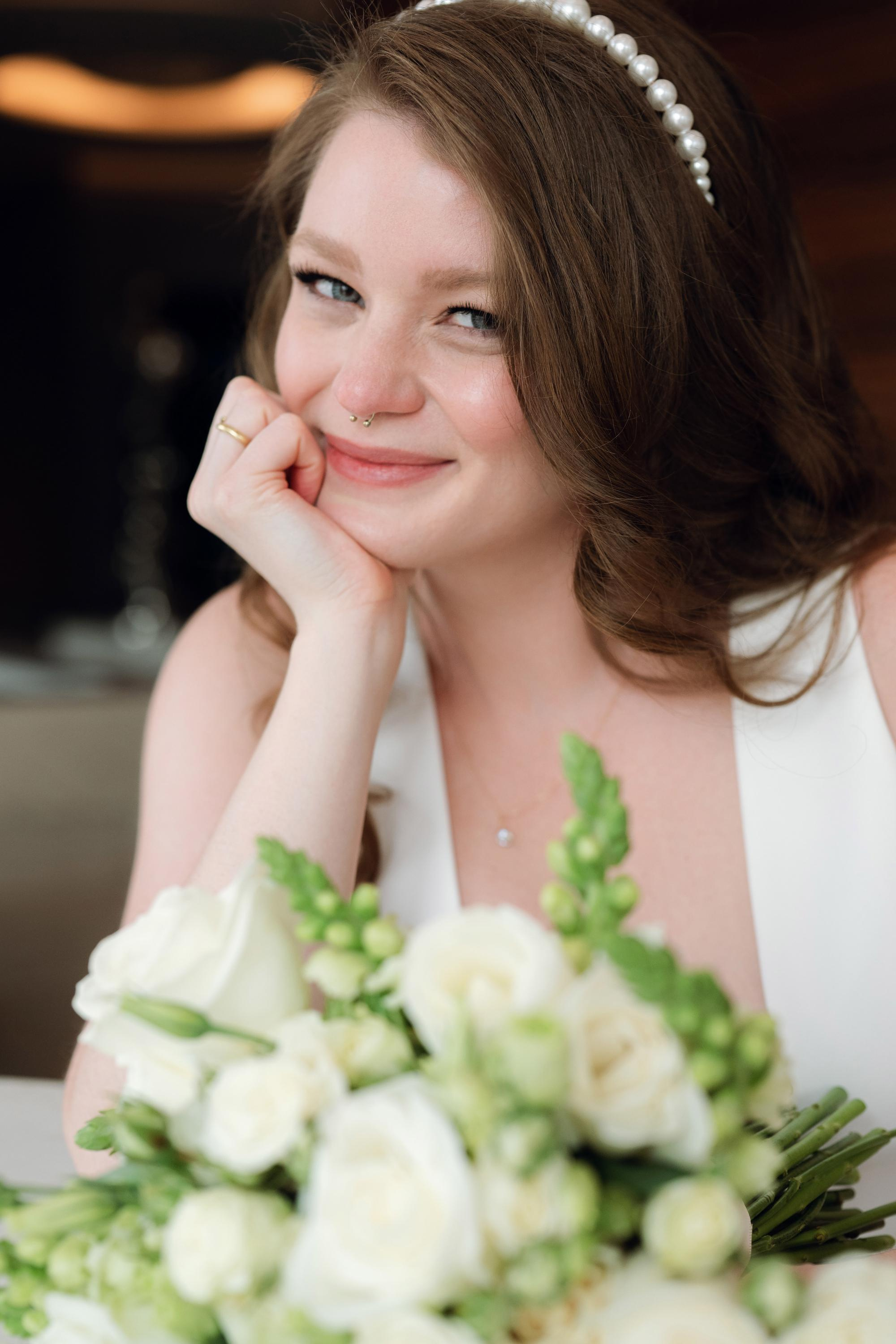 a woman in a white dress sitting at a table