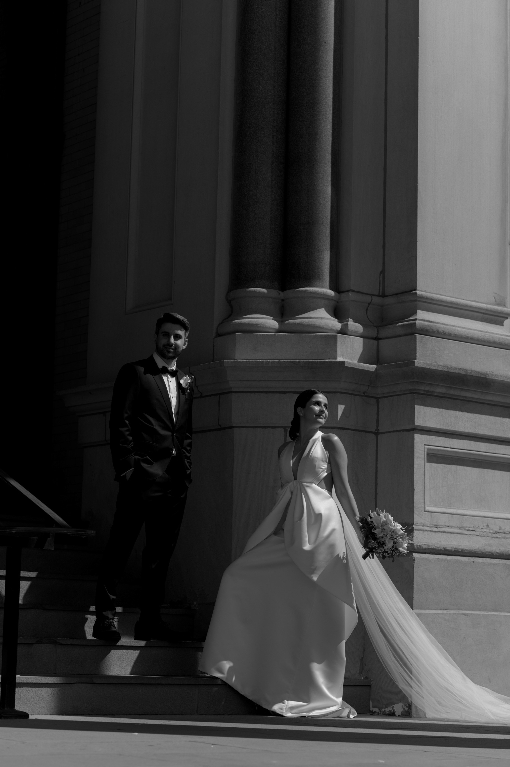 a bride and groom walking down the steps