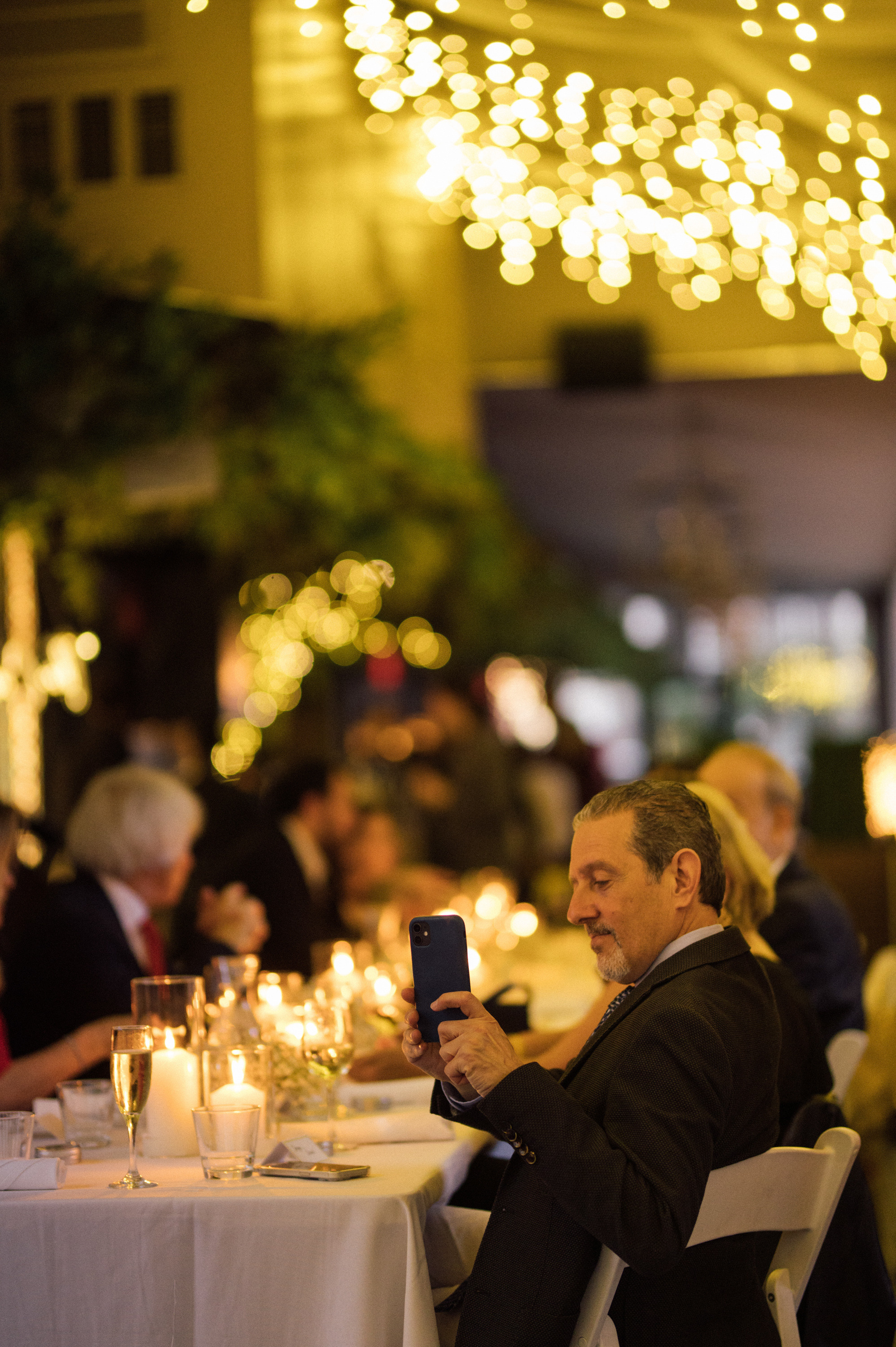 a man sitting at a table with a cell