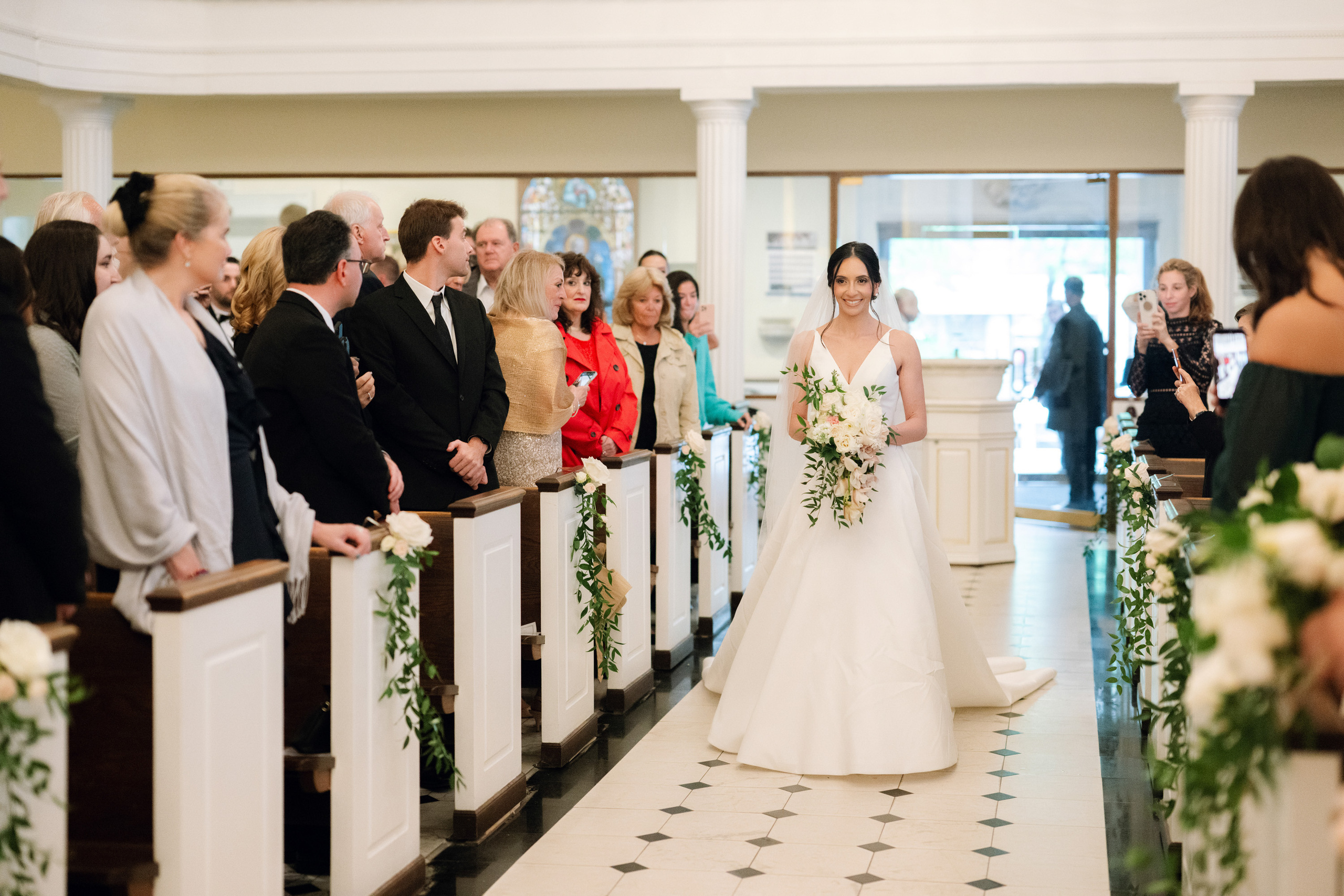 a bride walking down the aisle of a church