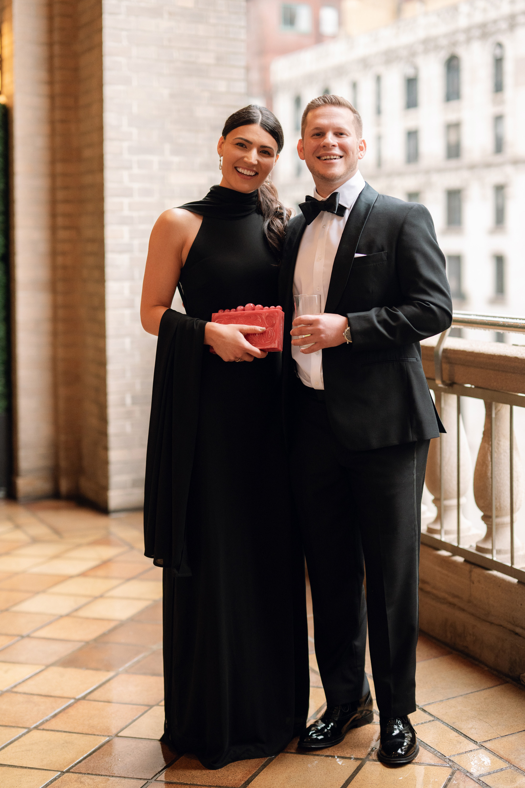 a man and woman in formal attire posing for a picture