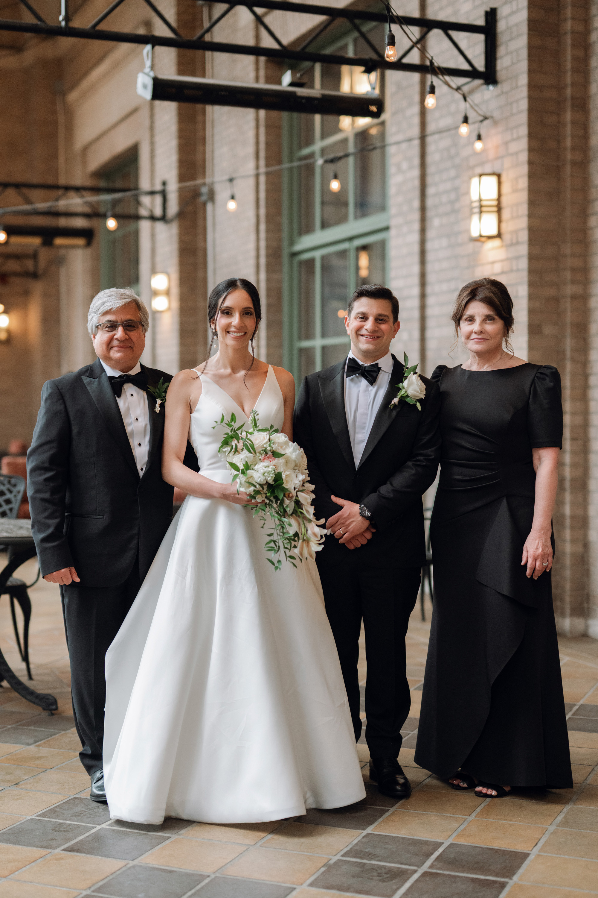 a bride and groom with their parents