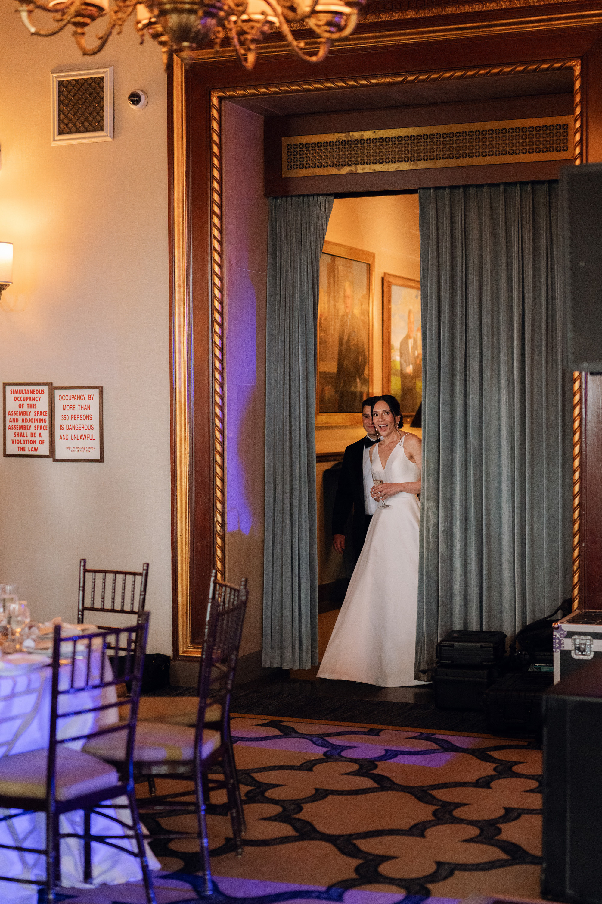 a bride and groom are standing in a room
