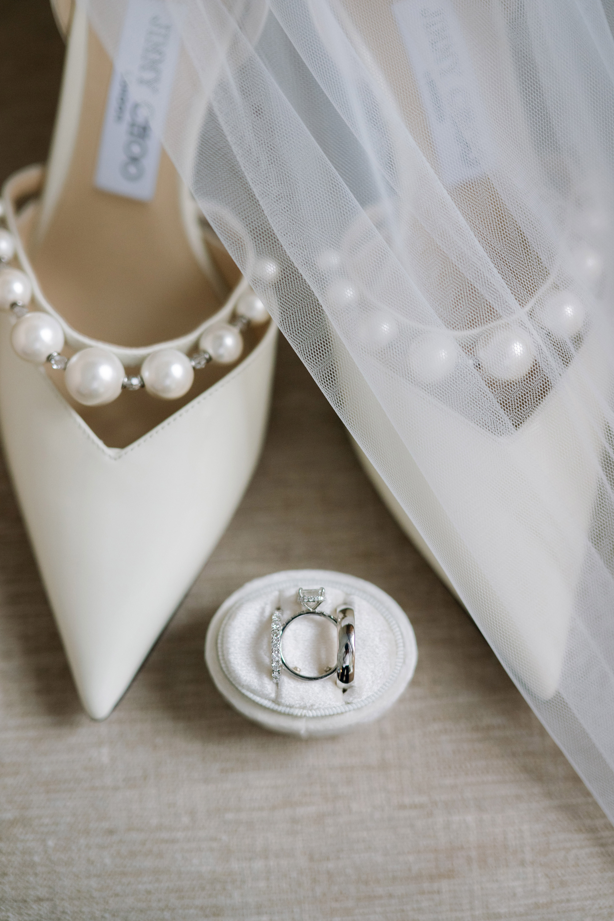 a pair of shoes and a ring on a table