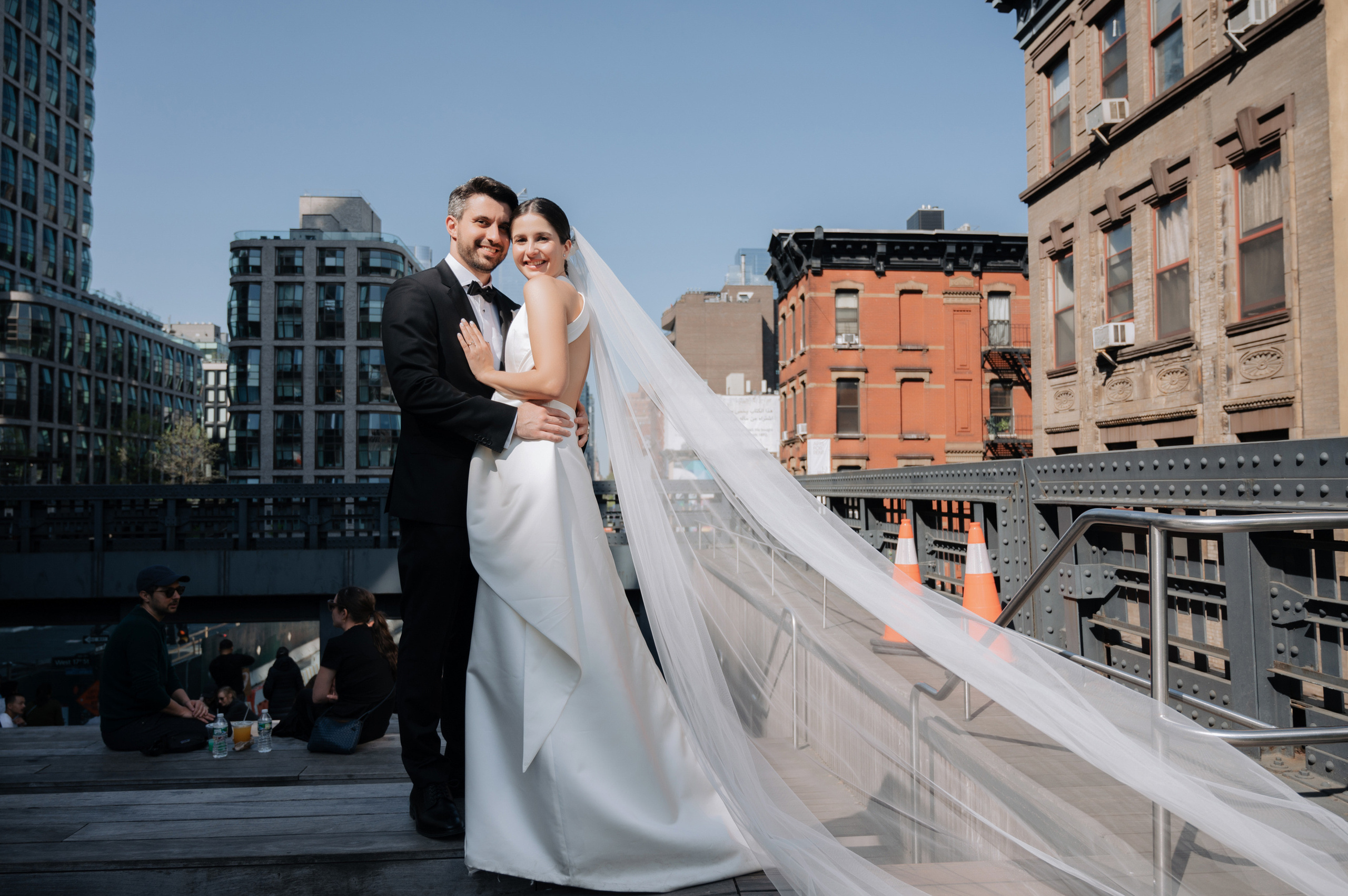 a bride and groom posing on a rooftop