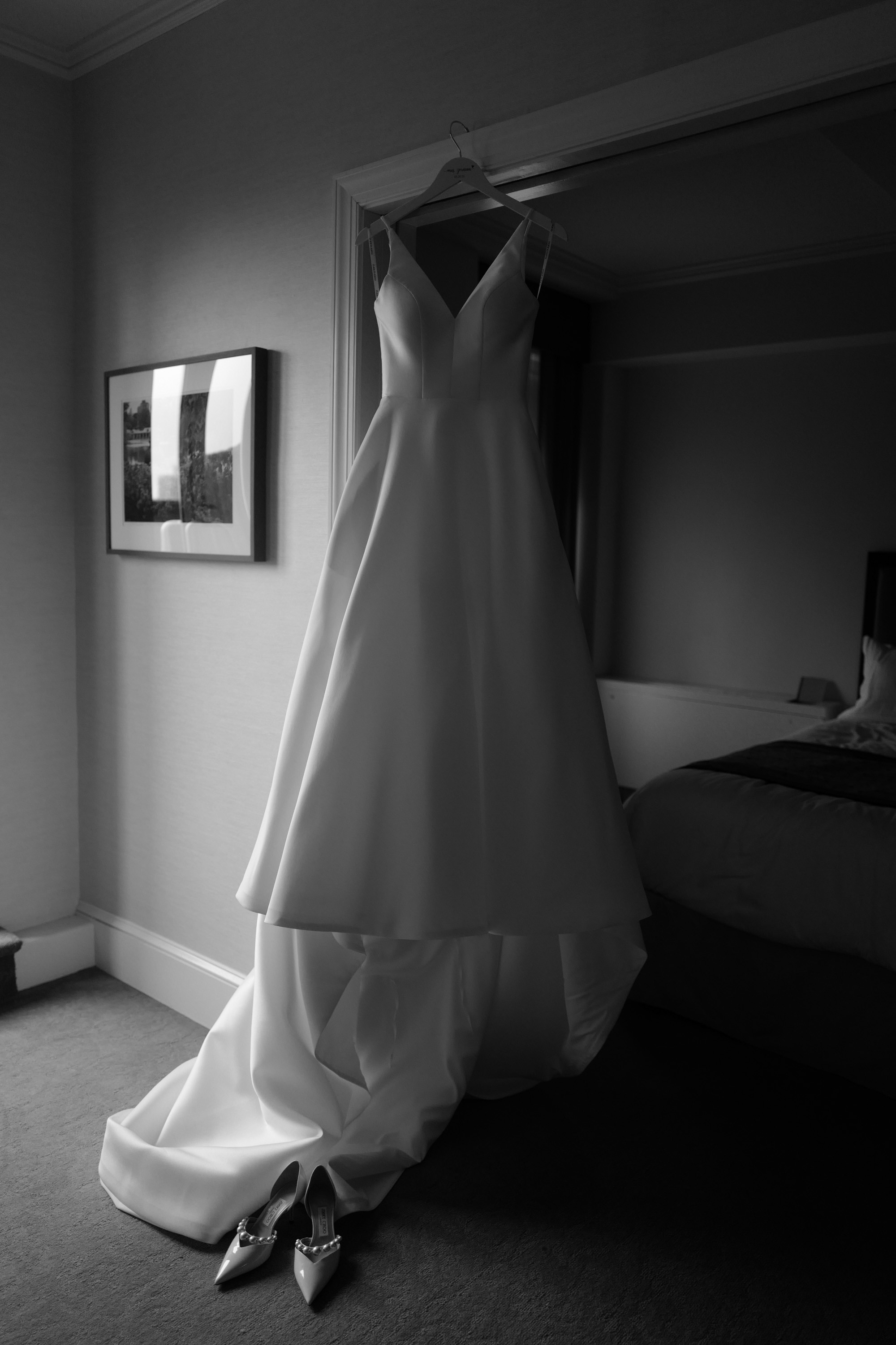 a wedding dress hanging in a room