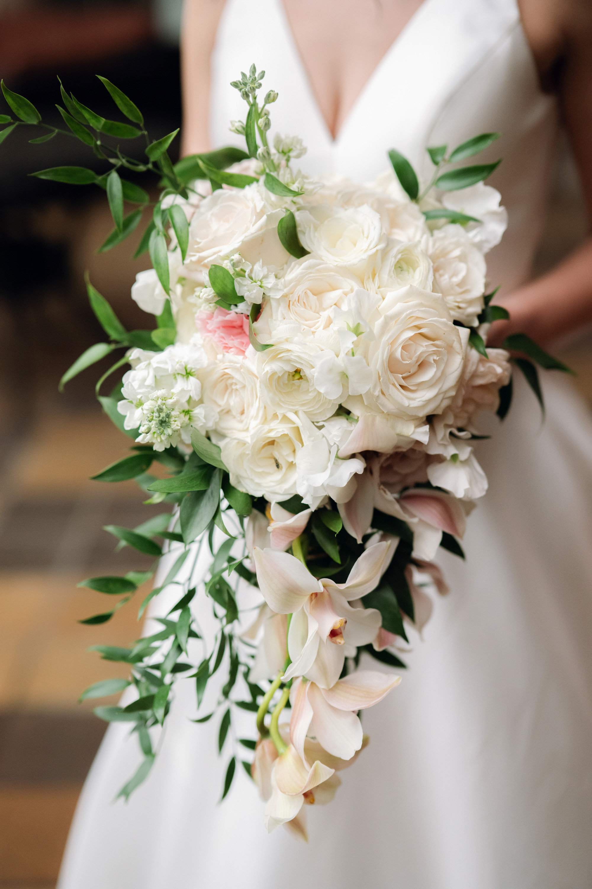 a bride holding a bouquet of white flowers