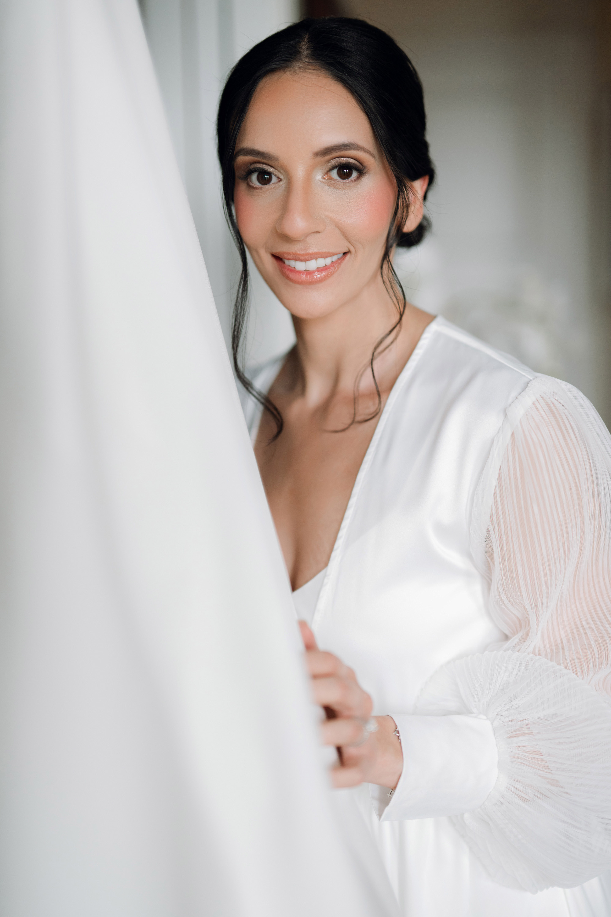 a woman in a white dress is smiling
