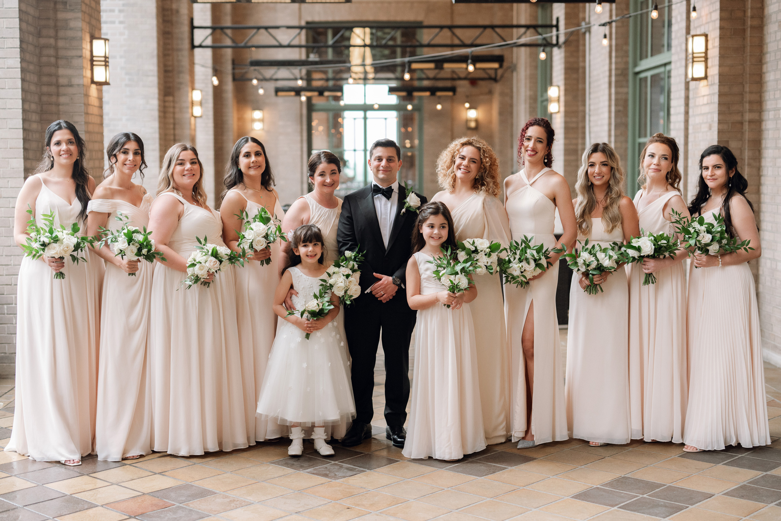 a bride and her bridesmaids pose for a photo