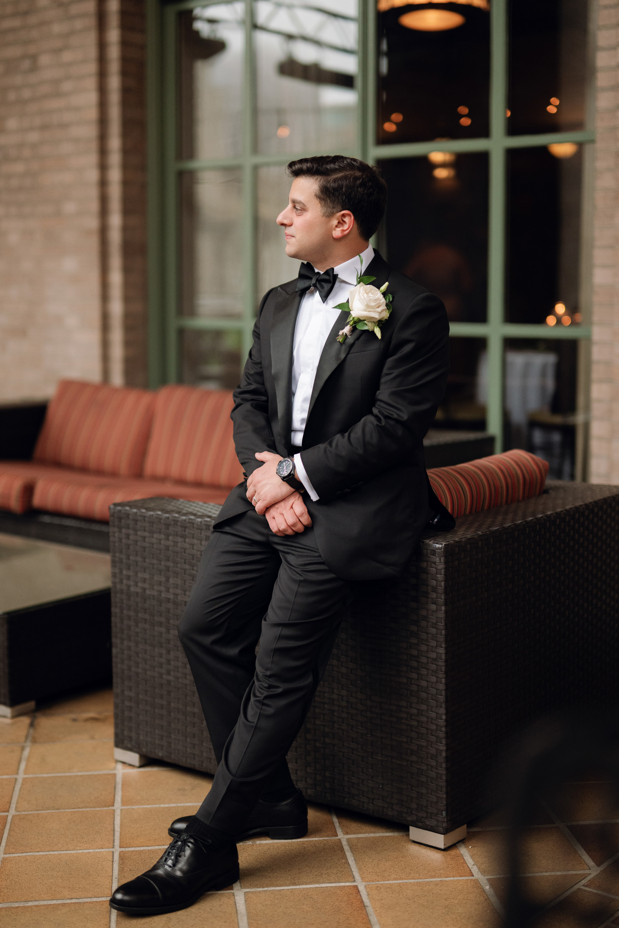 a man in a suit sitting on a couch