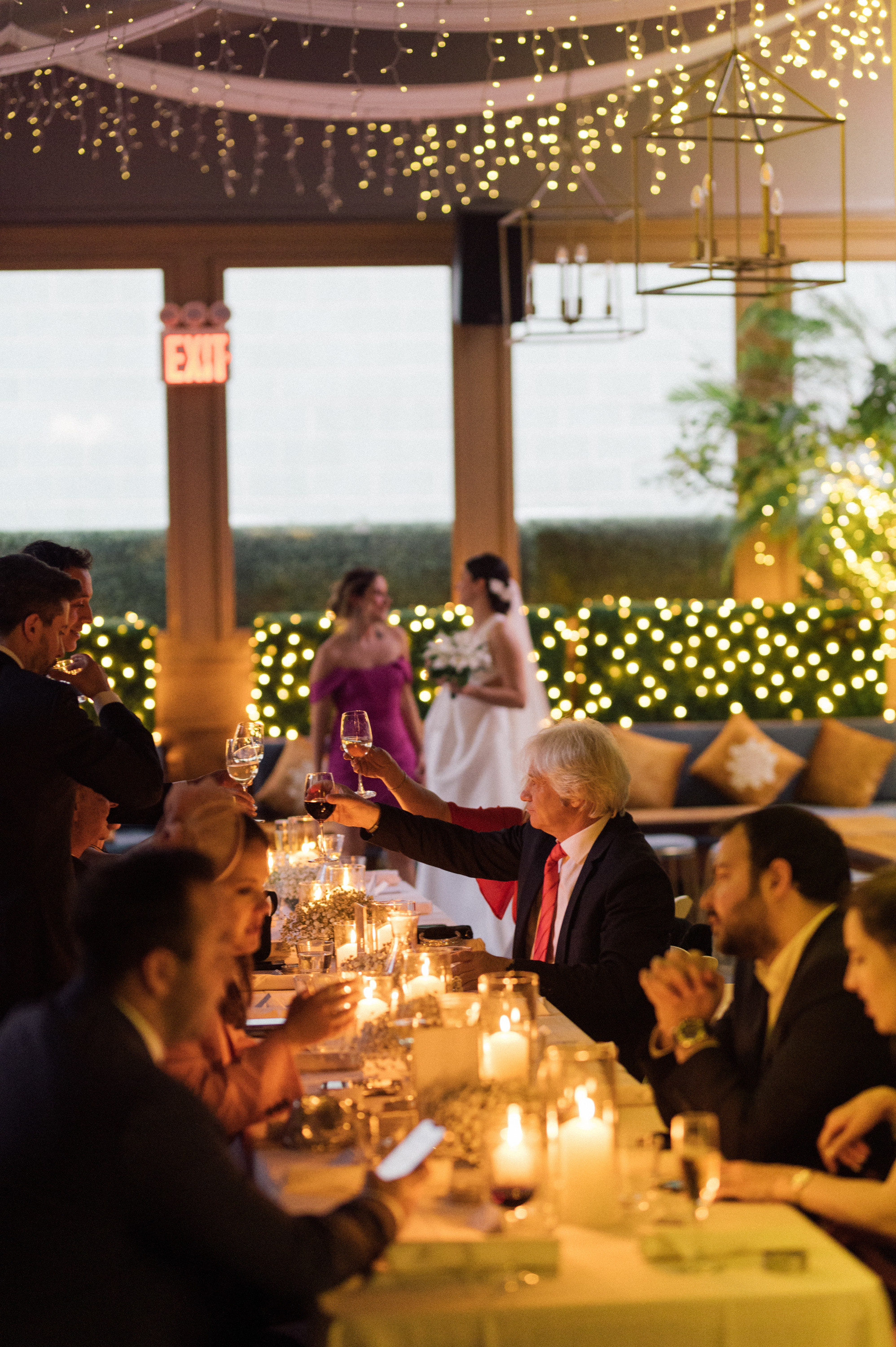 a group of people sitting at a table with wine glasses