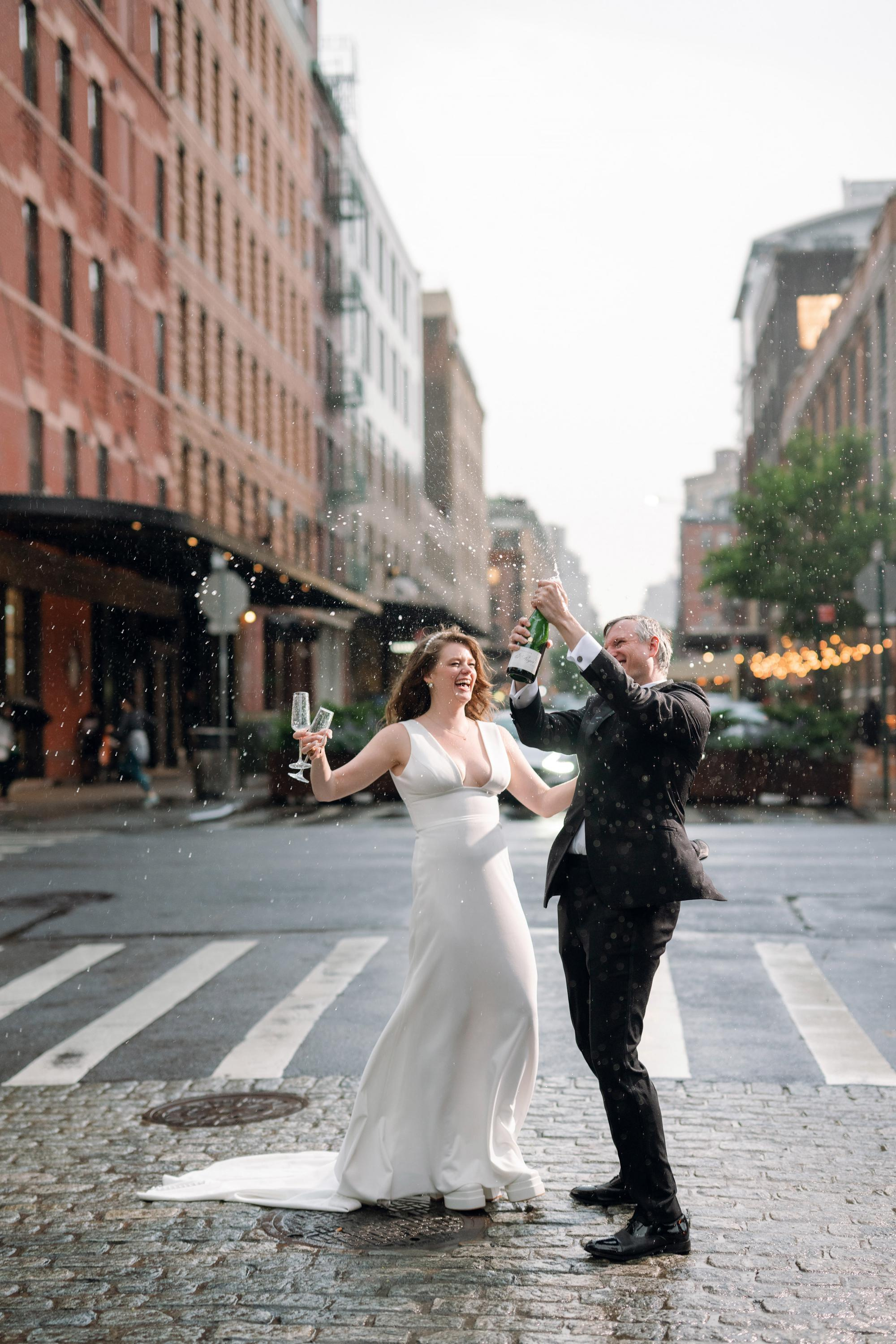a bride and groom are standing on the street