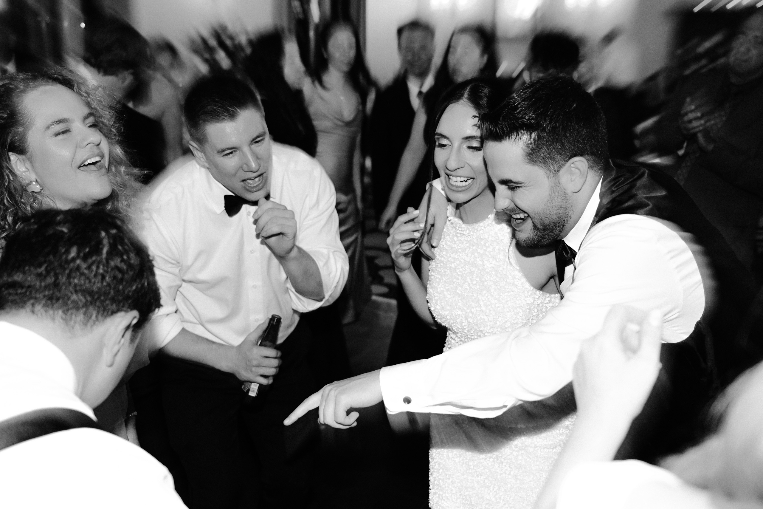 a group of people dancing at a wedding