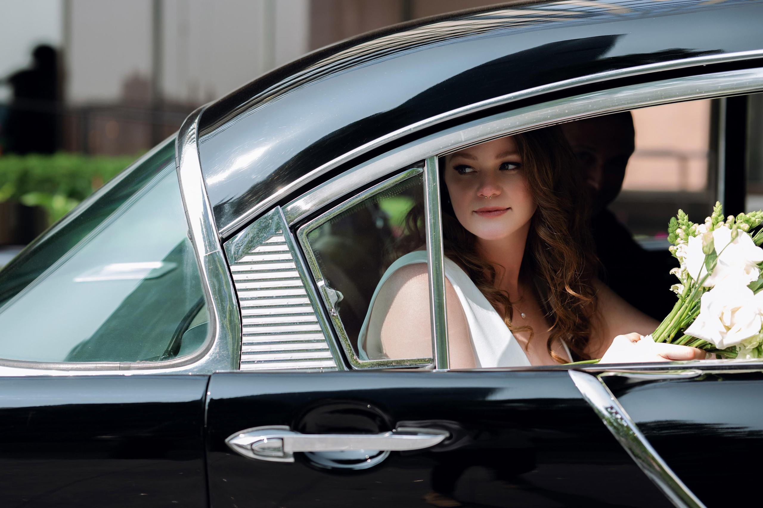 a bride in a black car