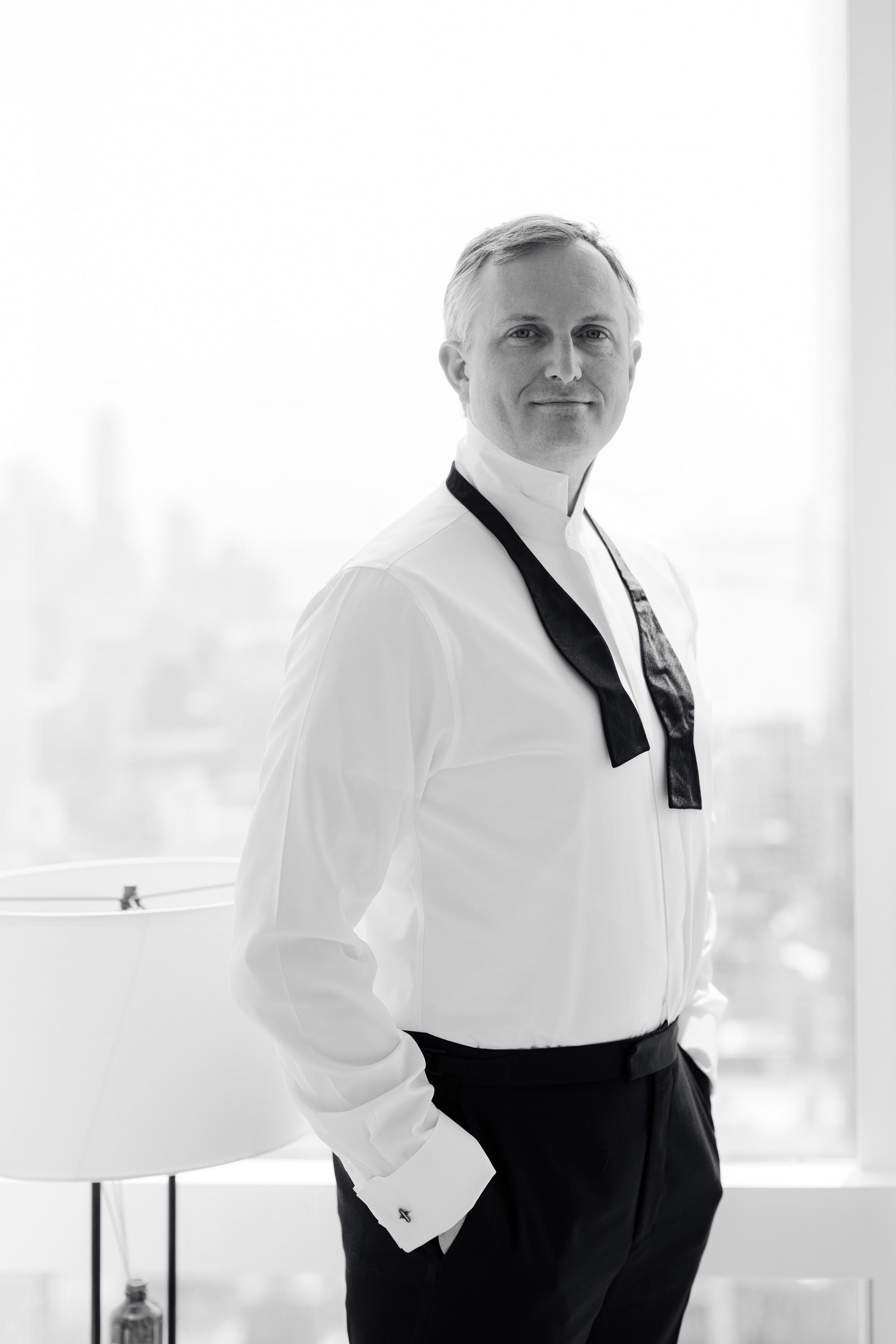 a man in a white shirt and black pants
