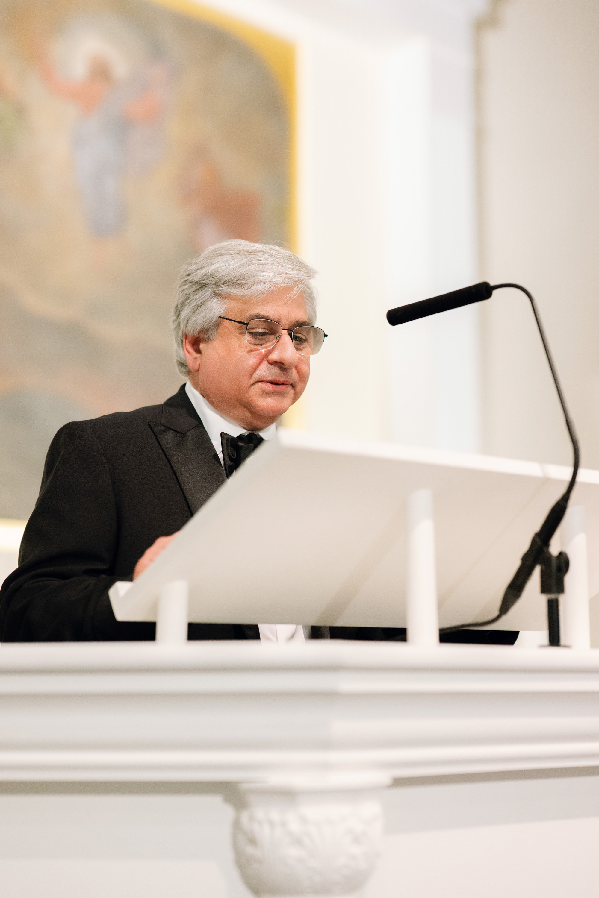 a man in a suit and tie is looking at a laptop