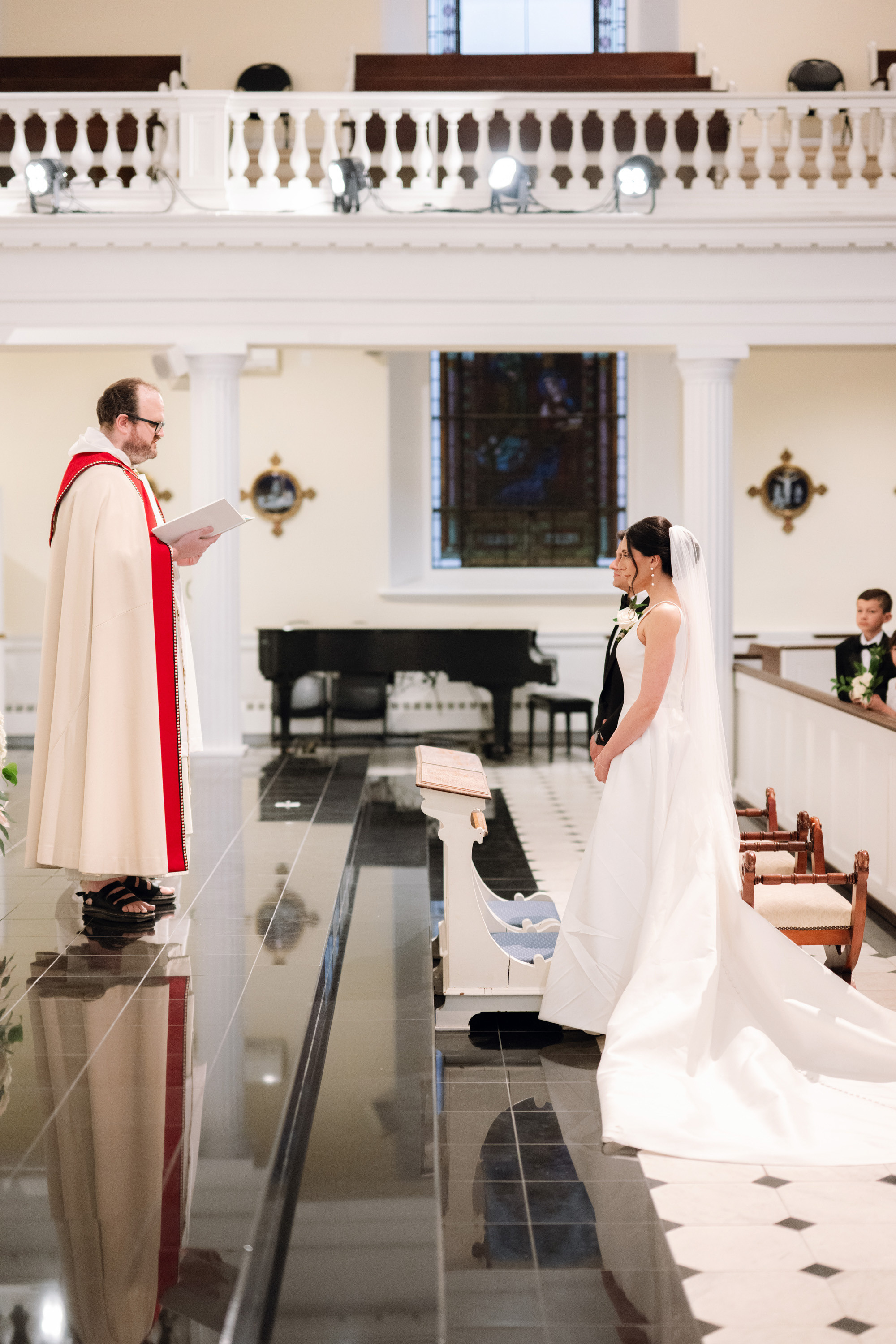 a bride and groom are sitting in a church