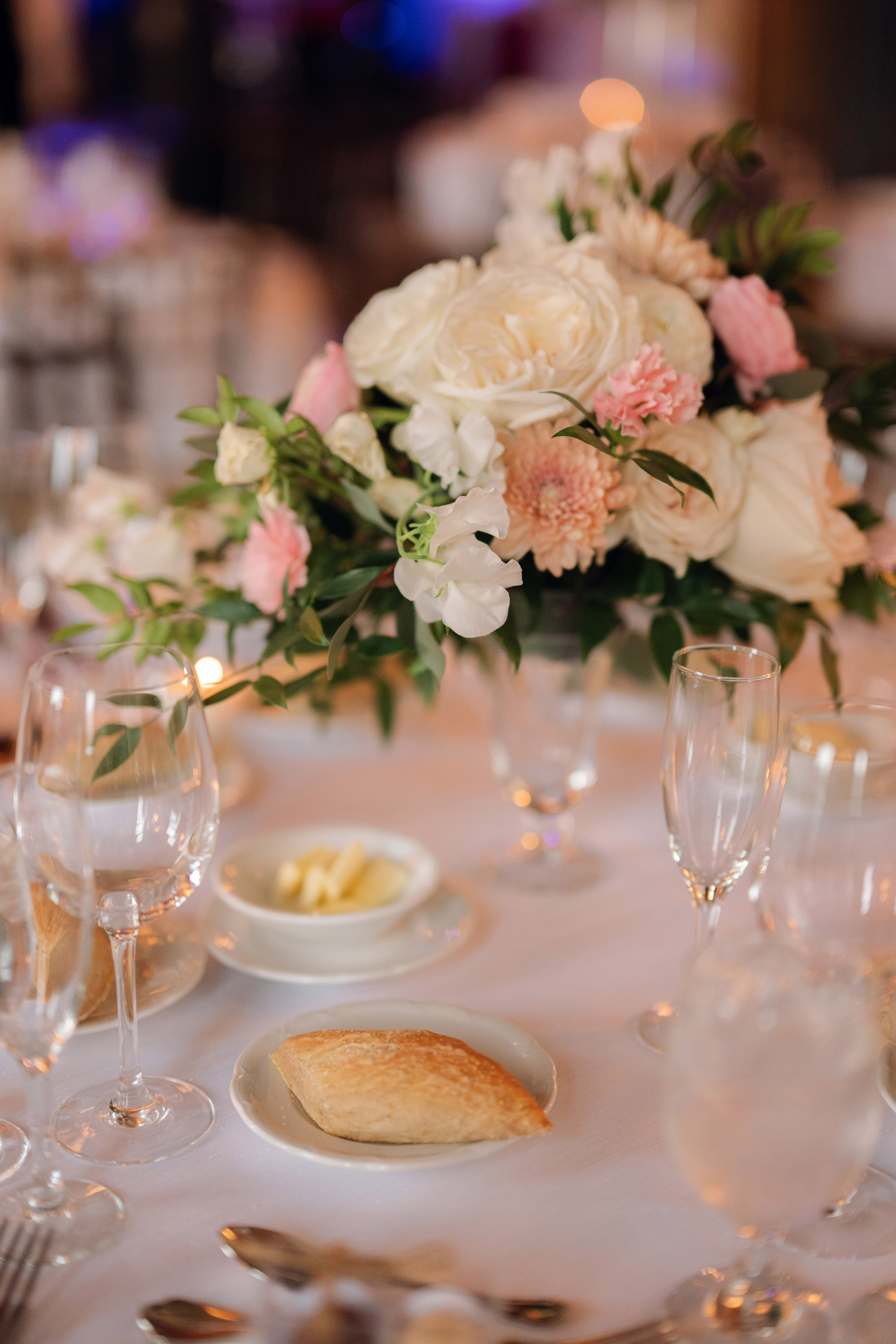 a table with a white table cloth and a vase of flowers