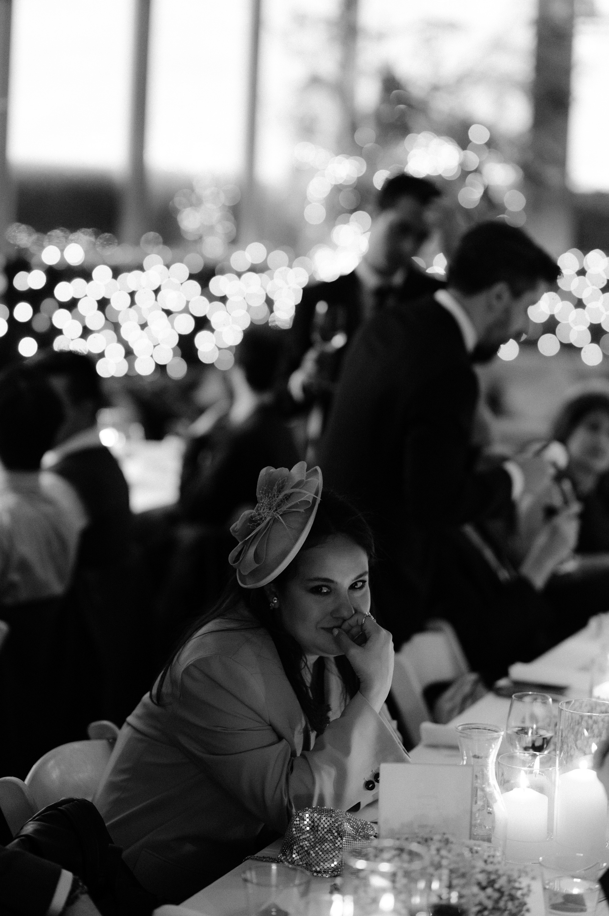 a woman sitting at a table with a candle