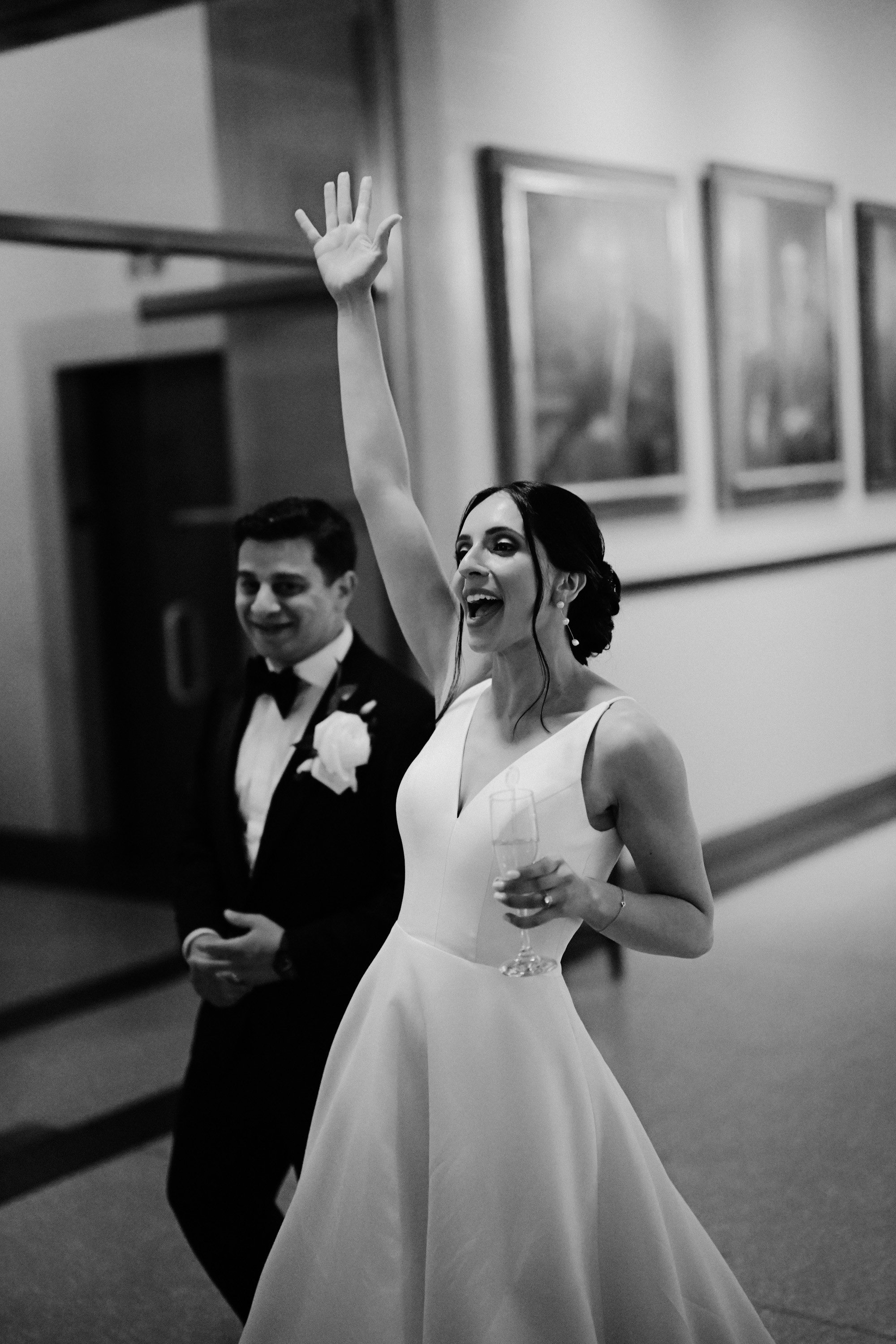a bride and groom dancing in a hallway