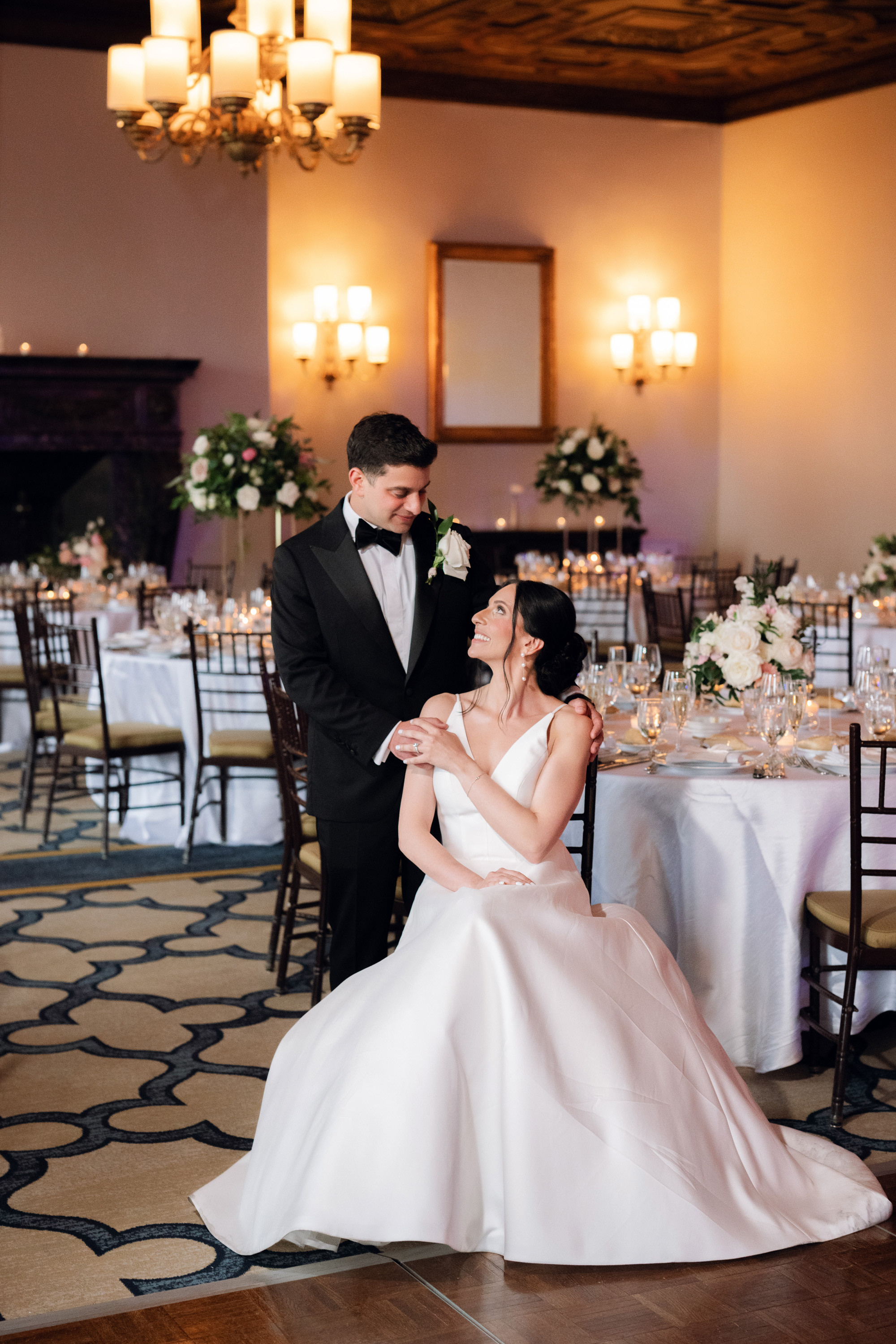 a bride and groom are sitting at their wedding reception