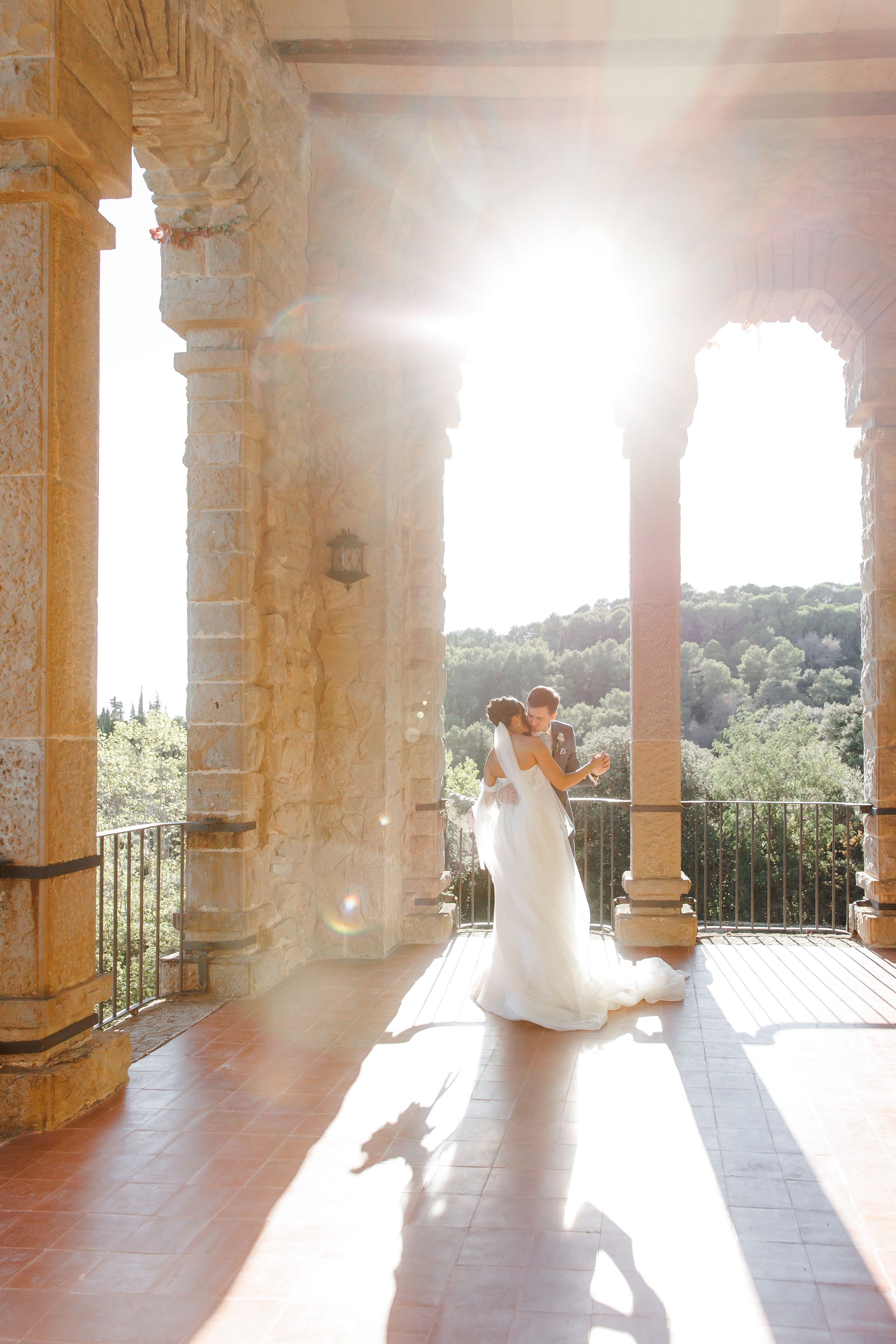 Bride and groom dancing during their wedding portrait session in the wedding venue, capturing pure happiness.