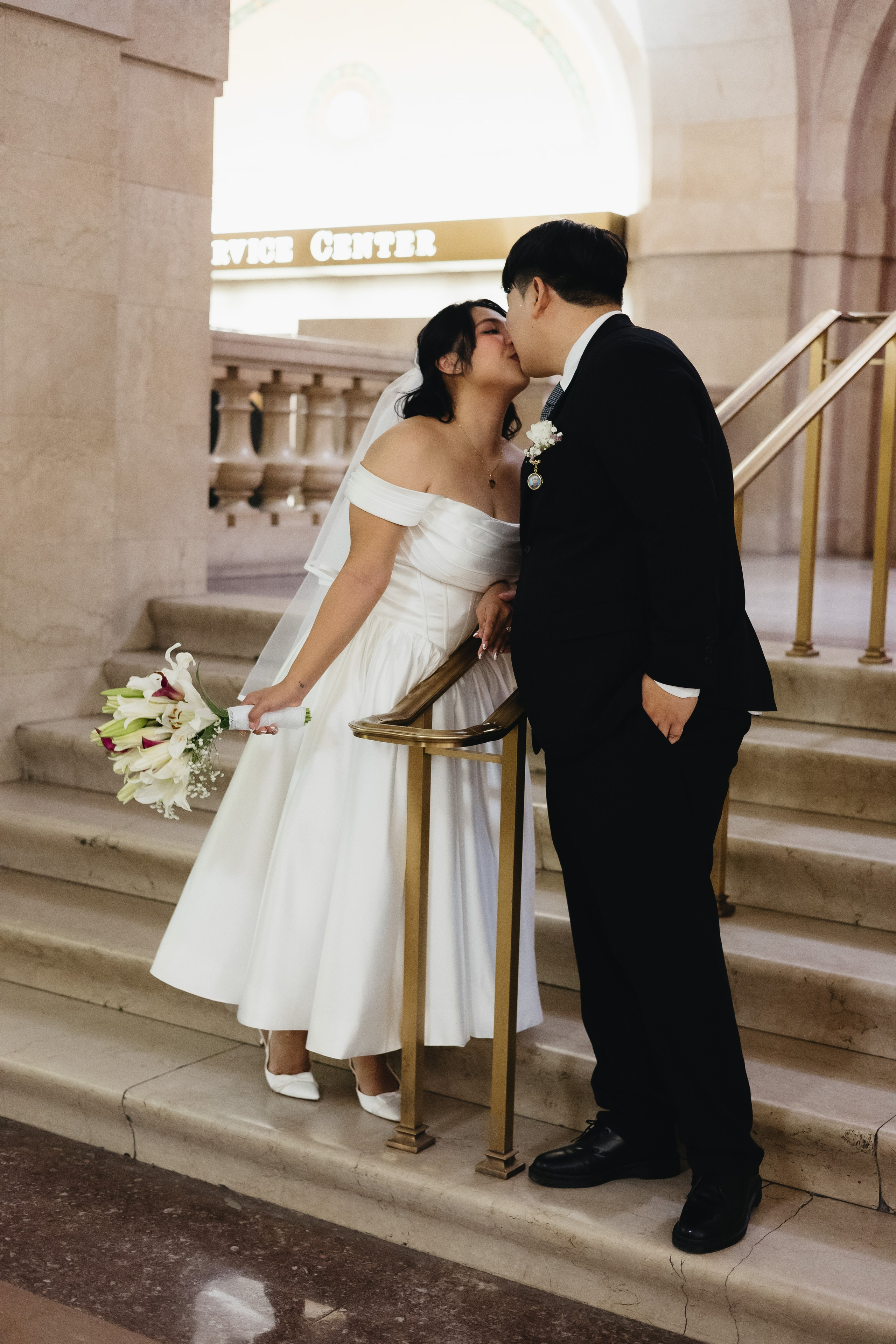 Couple kissing on the interior steps of Chicago City Hall