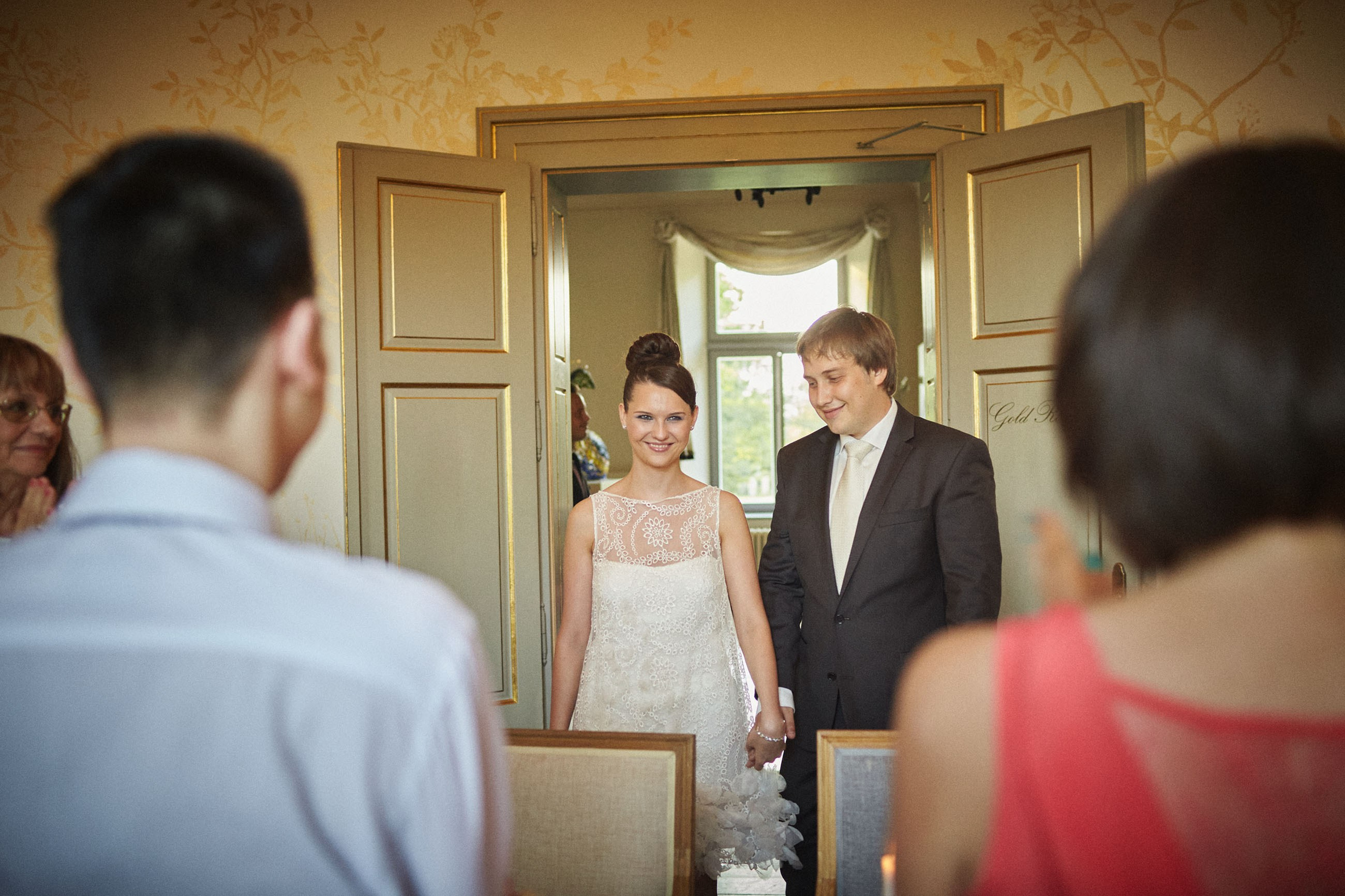 The beaming newlyweds are greeted by family and friends as they make their entry into the ballroom for their evening diner and festivities at the Chateau Mcely.