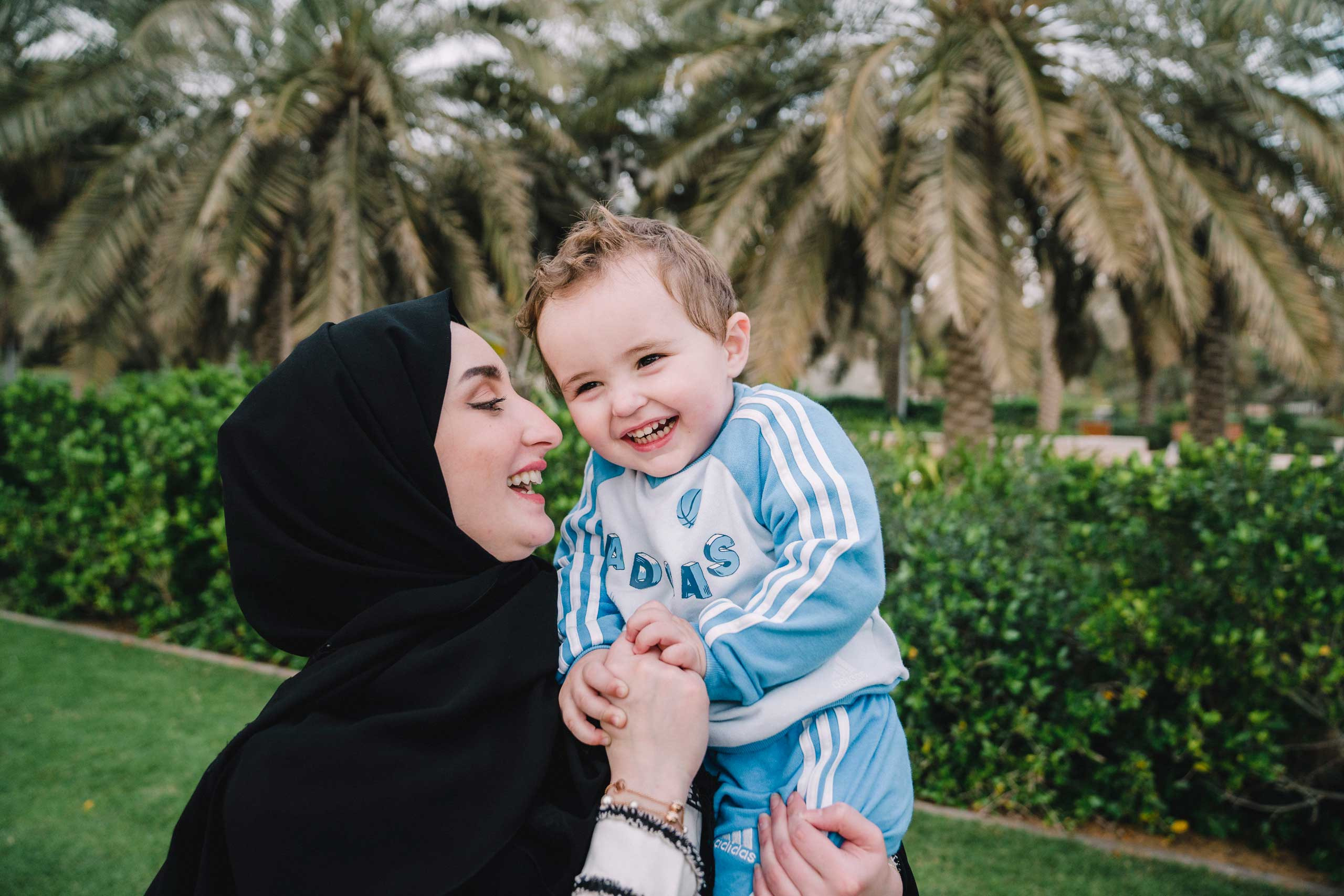 mother and her child chilling at the park and smiling happily