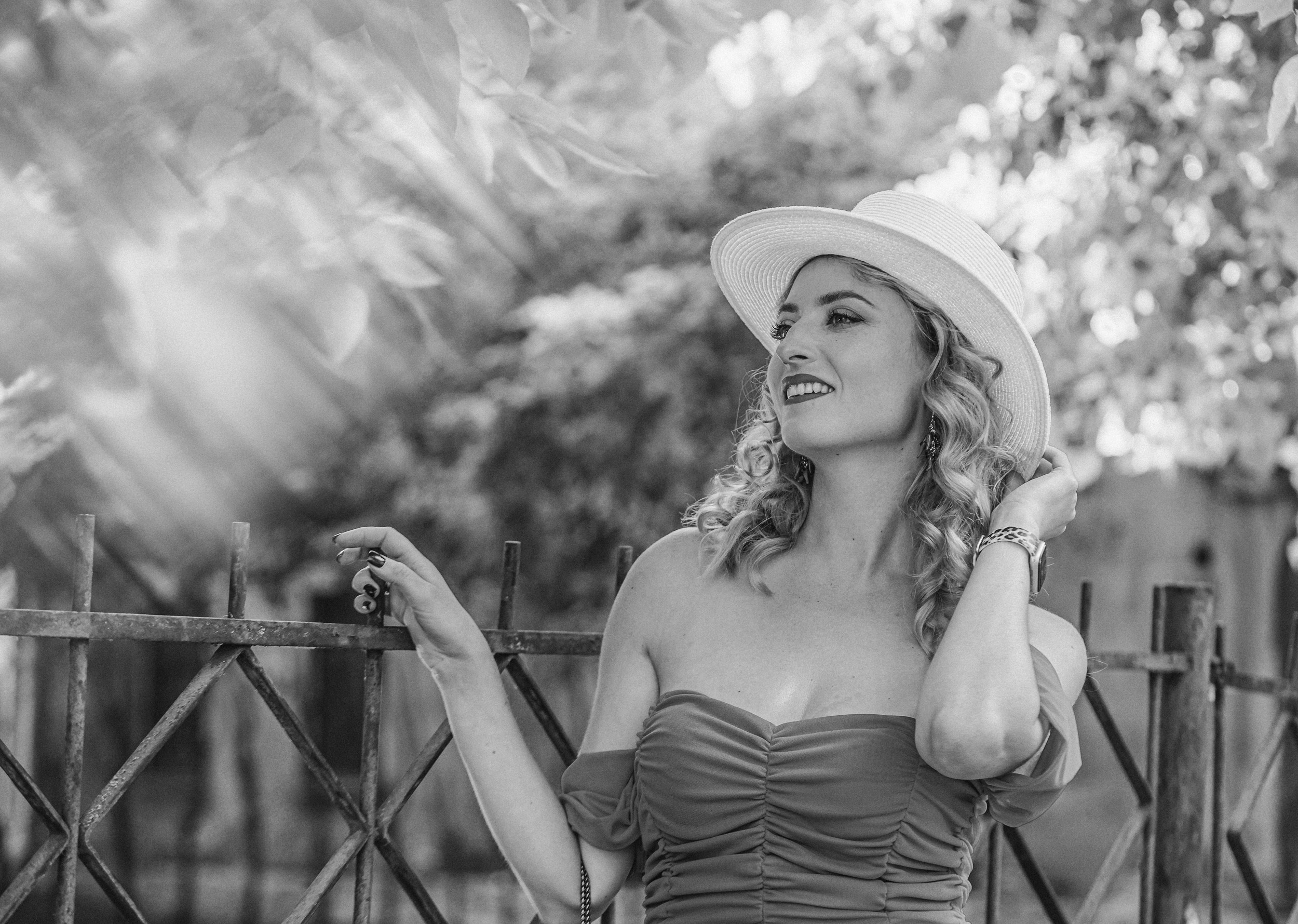 Beautiful woman with long hair in a hat, black and white photo, Riga photographer