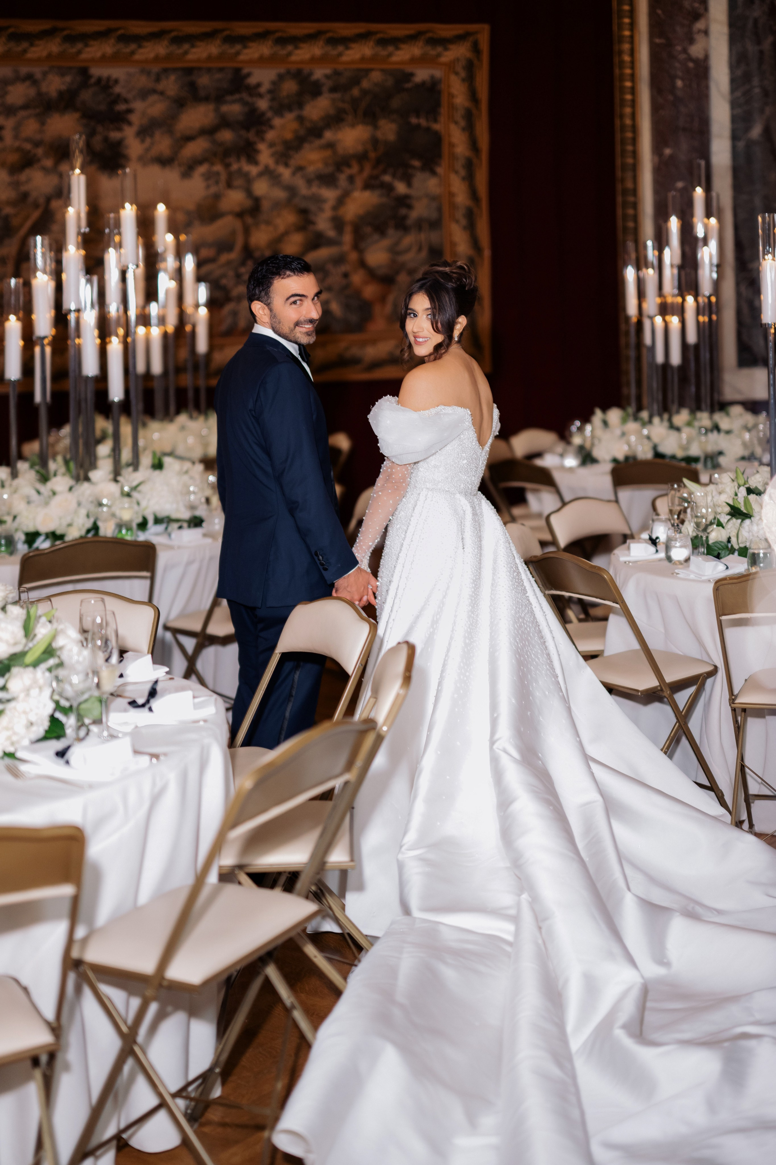 a bride and groom standing in front of a table