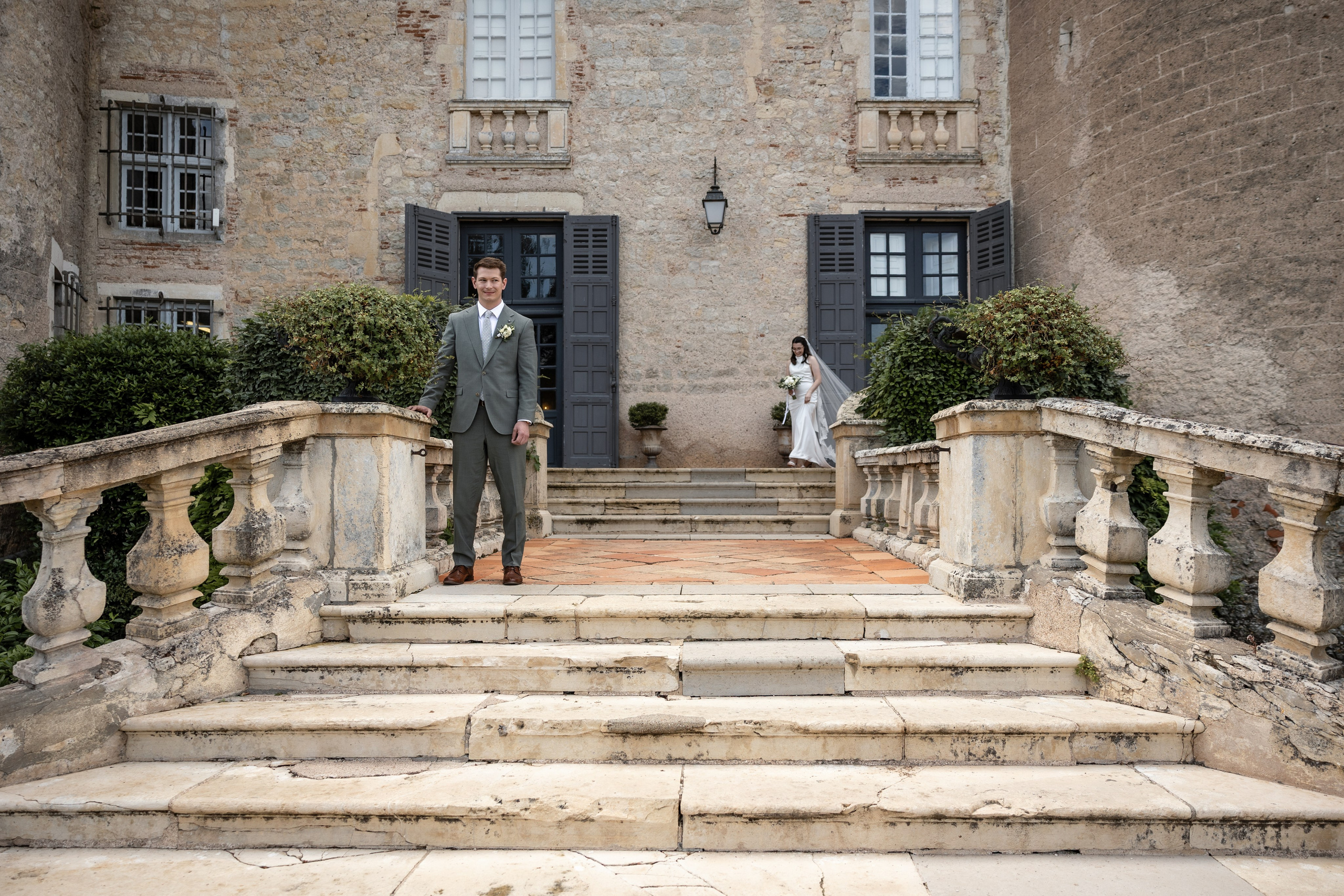 Bride and groom's first look on the stone staircase at Château Mercuès