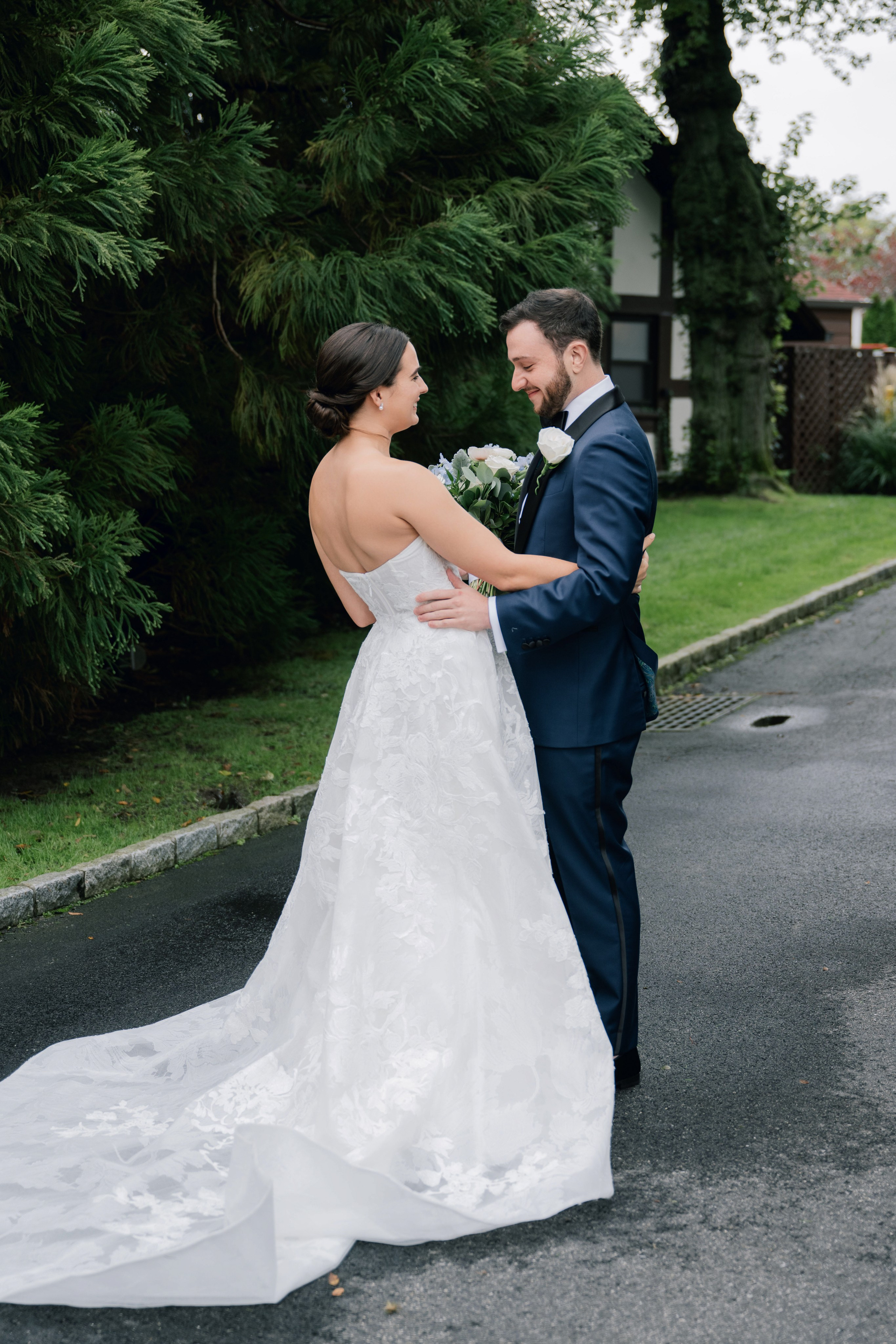 a bride and groom standing in the street