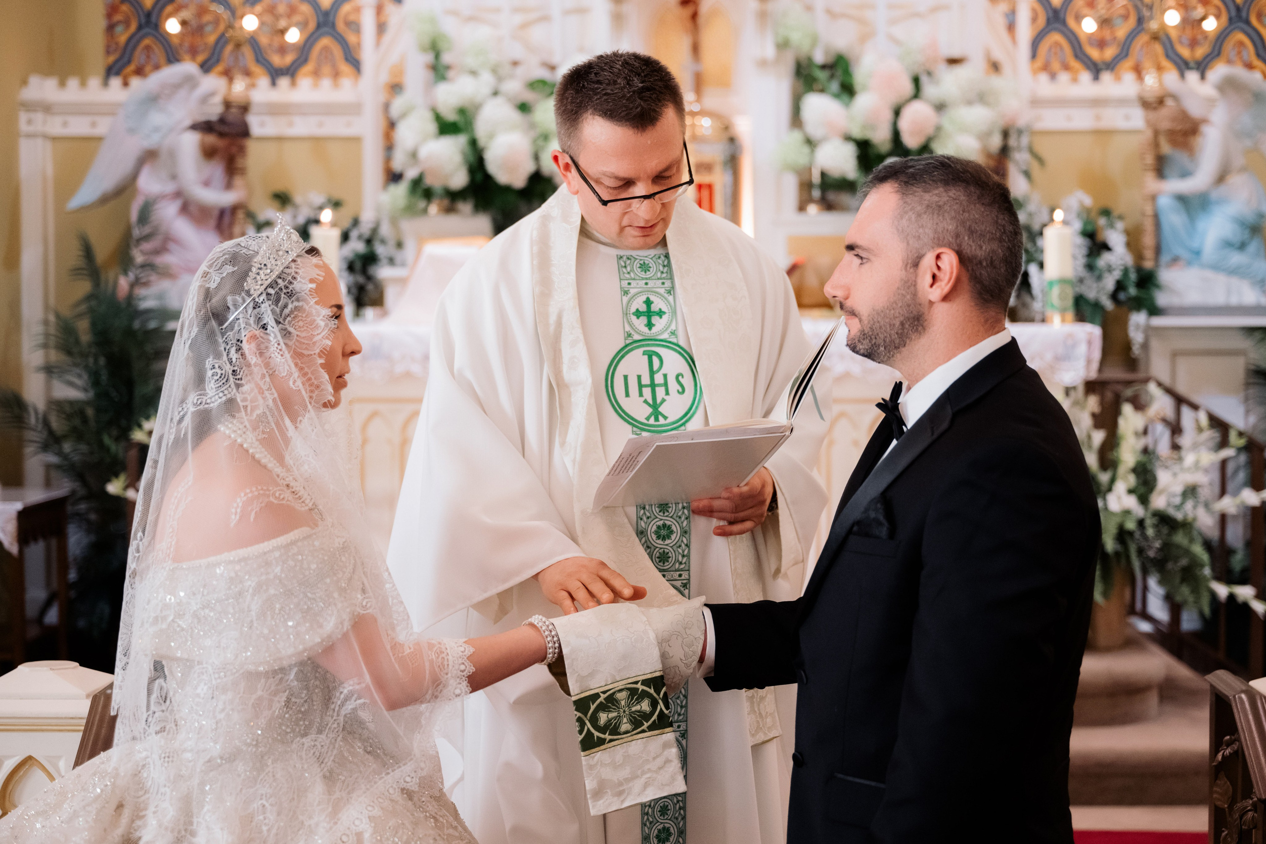 a man and woman are holding a wedding ring