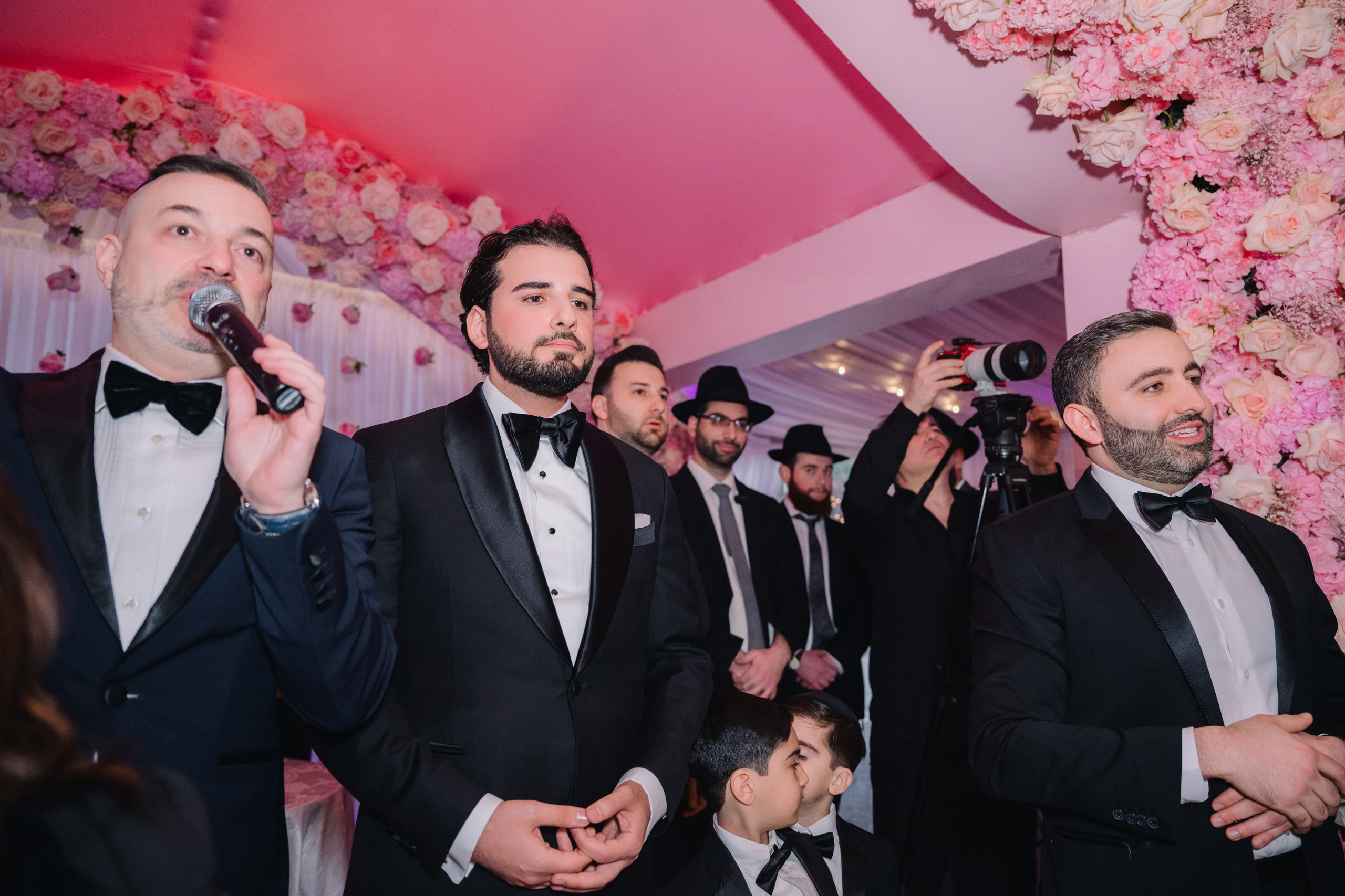 grooms singing at a wedding