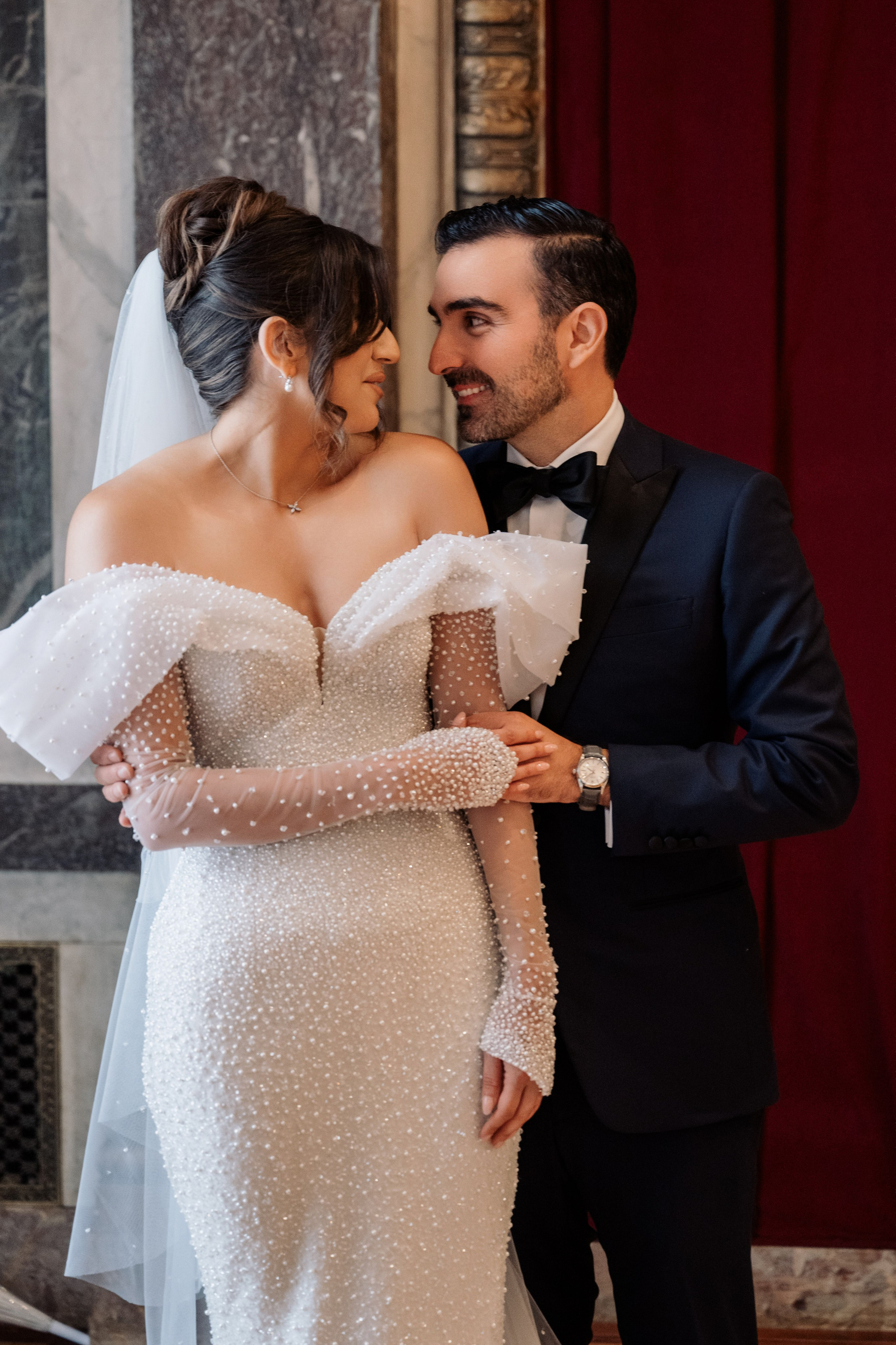a bride and groom pose for a photo
