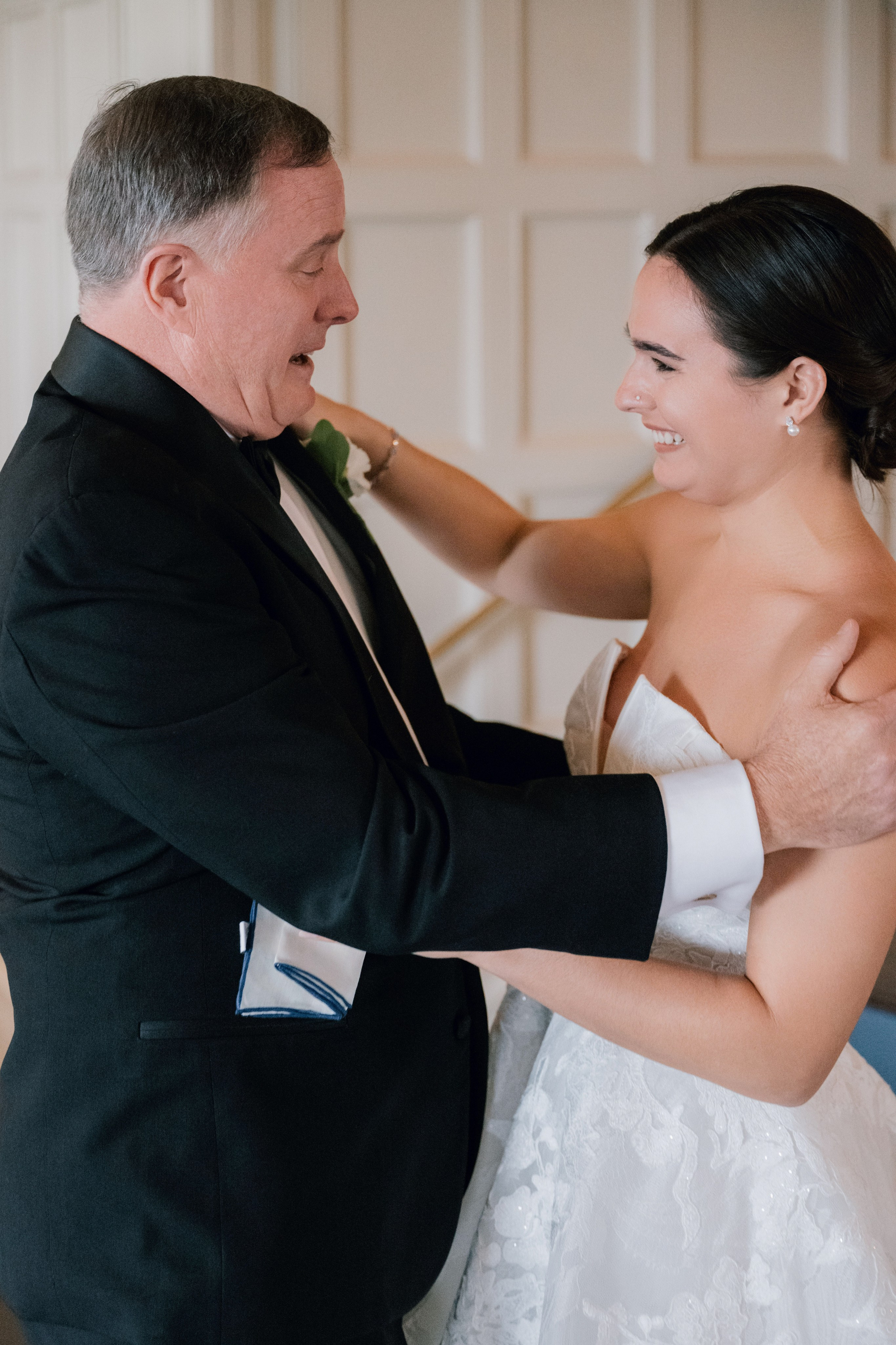 a man helping a woman into her wedding dress