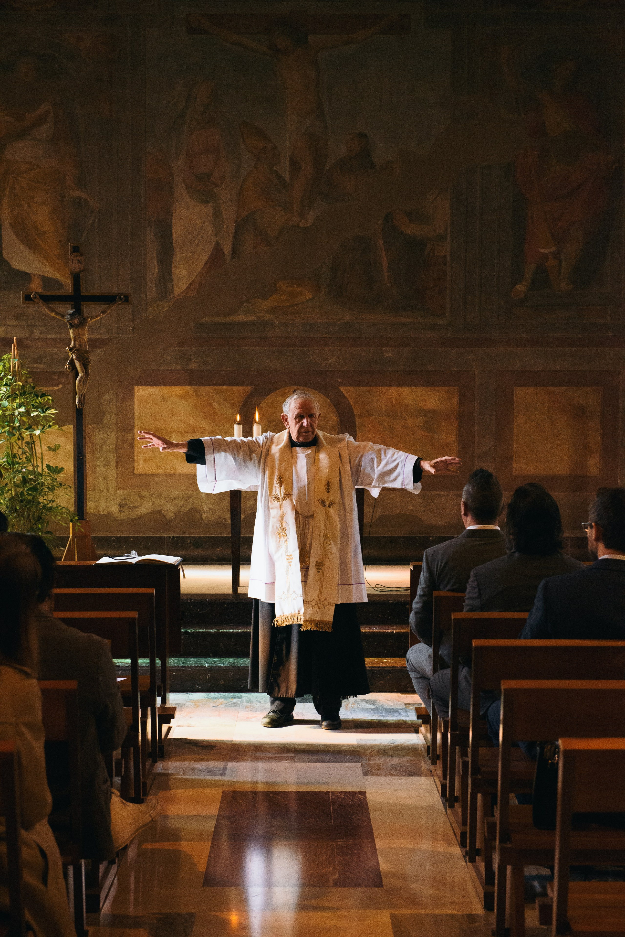 Father at the homily of the Baptism in Milan in church. Professional photographer