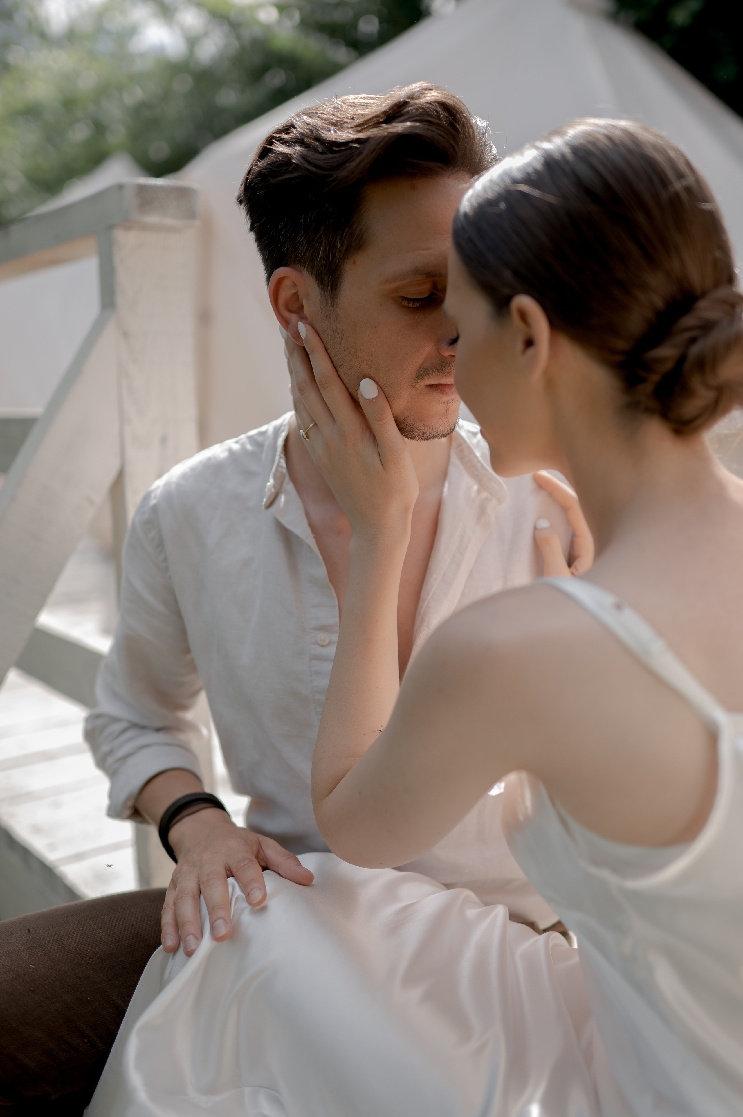 Within a private garden sanctuary, the couple's wedding morning is imbued with the warmth of glamping tents, offering a tranquil setting for their loving and tender connections.