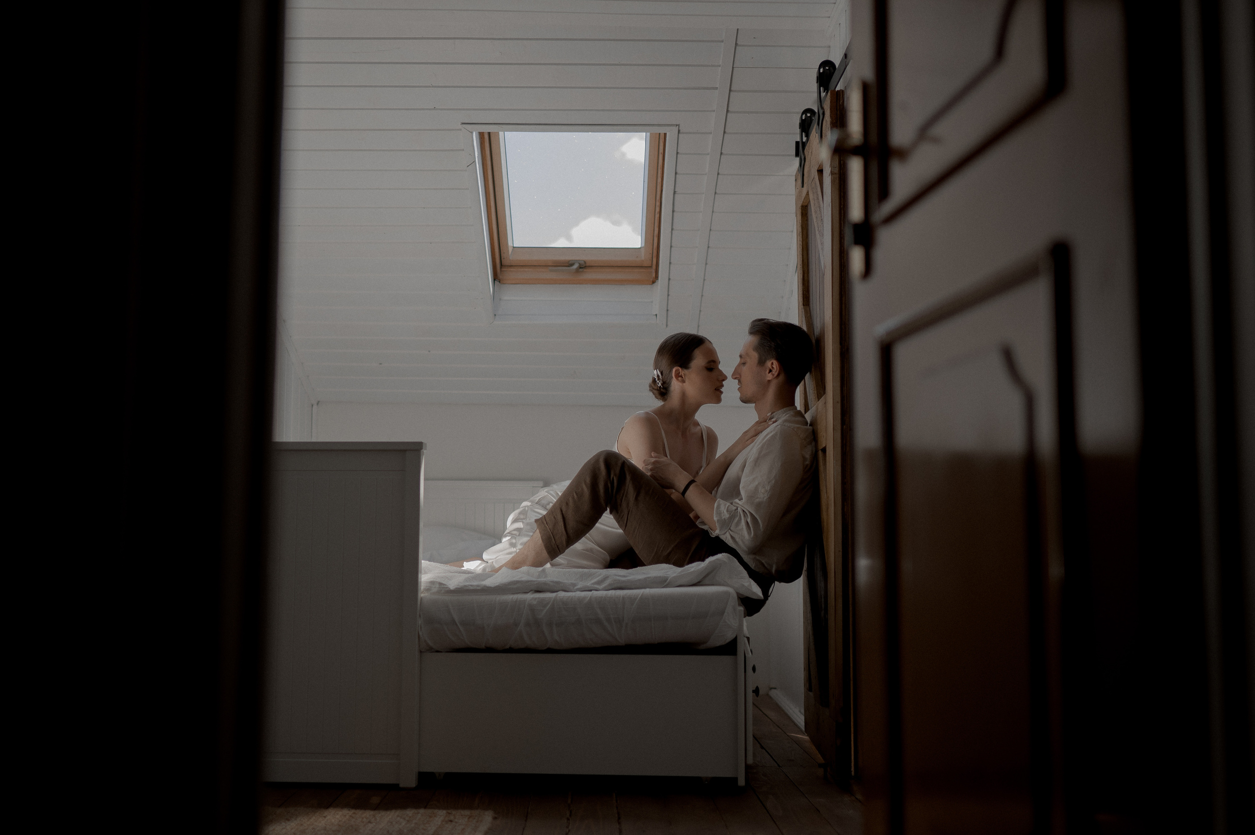 Wedding morning serenity captured as the couple cherishes quiet moments in bed, brimming with love and excitement for their special day.