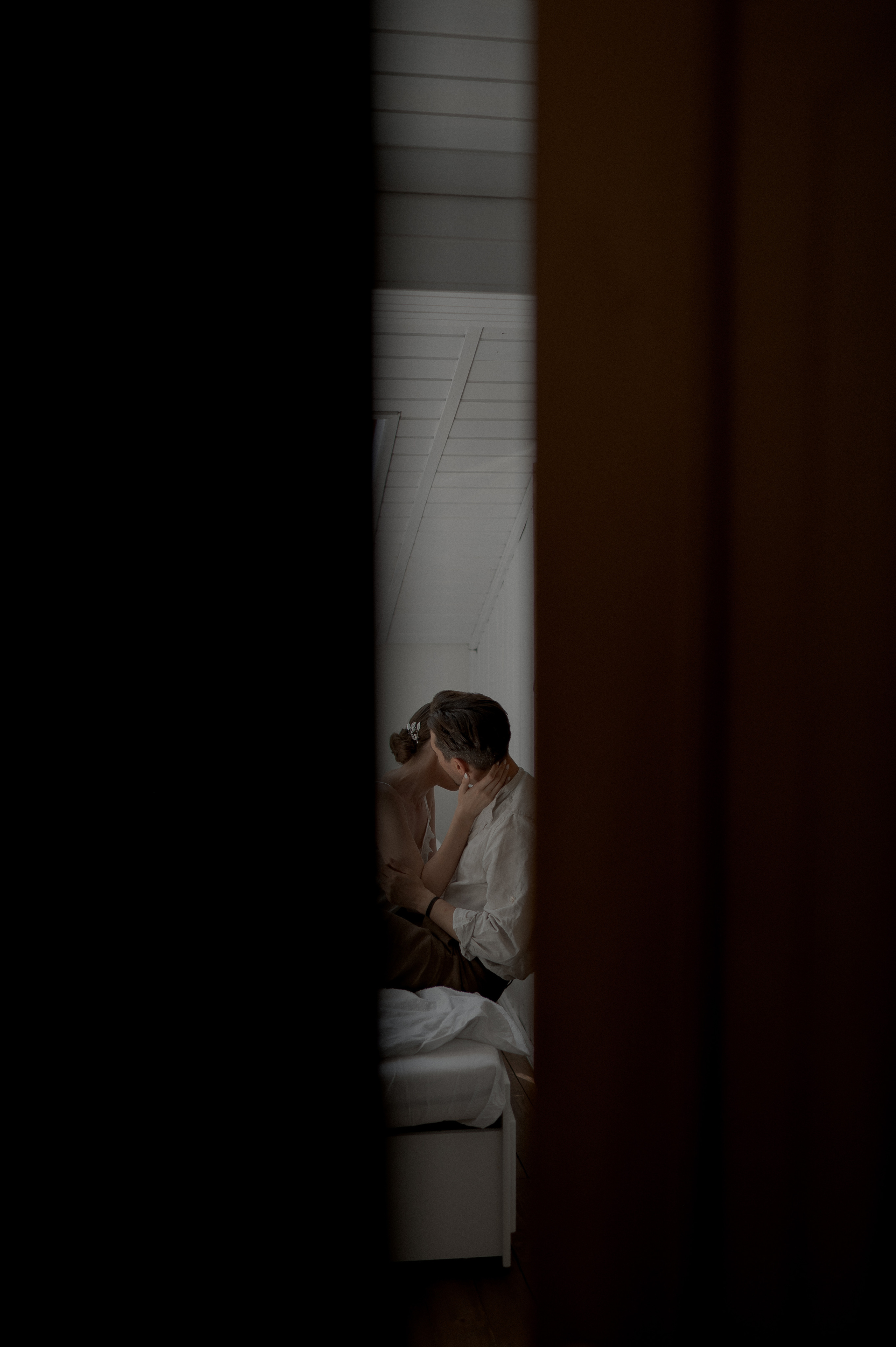In the quiet moments of the wedding morning, the couple shares affectionate gestures in bed, nurturing their love and anticipation.