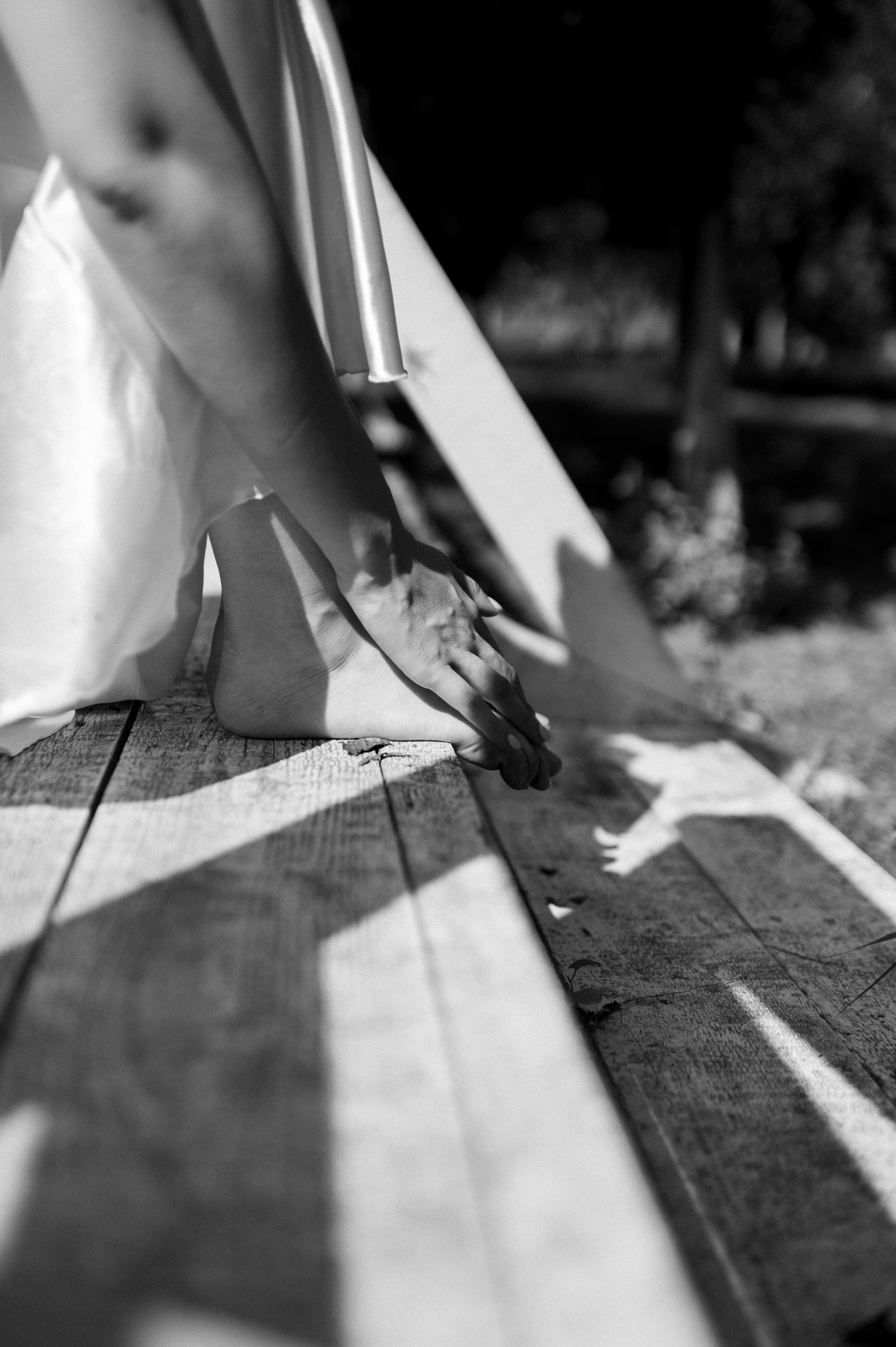 Wrapped in the allure of the wedding morning, the delicate bride's satin dress embraces her silhouette, creating a vision of ethereal beauty.