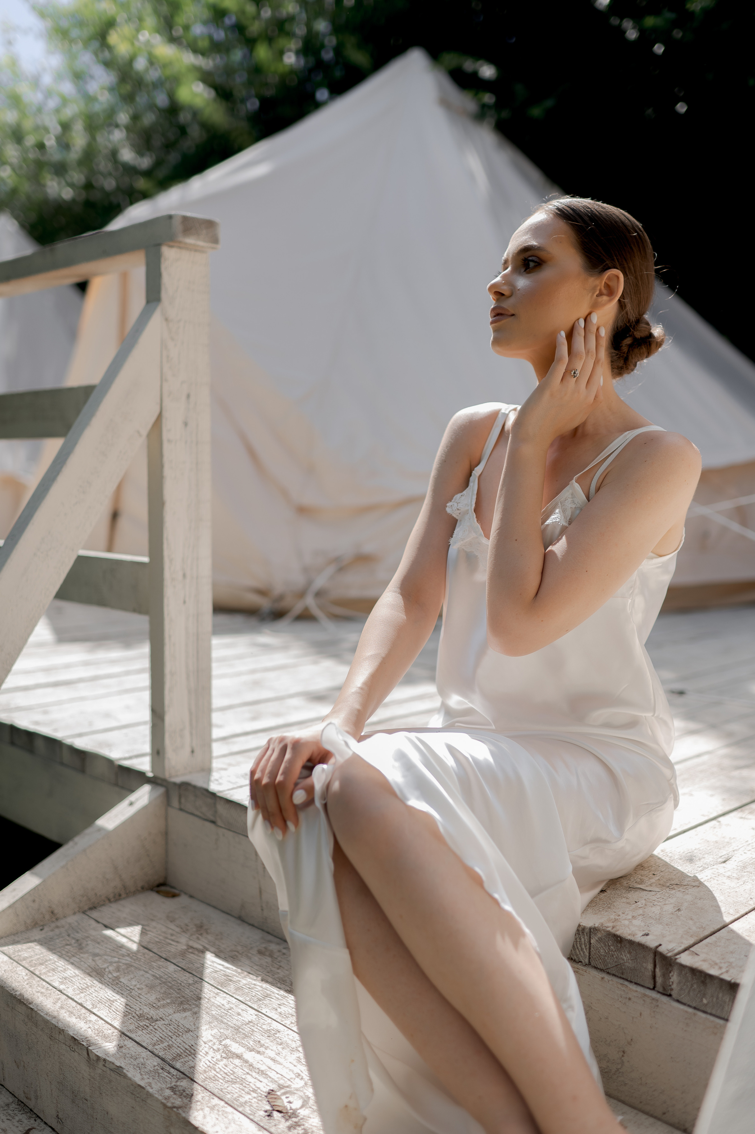 As the sun gently illuminates the wedding morning, the delicate bride graces the scene in a satin dress, radiating elegance and sophistication.