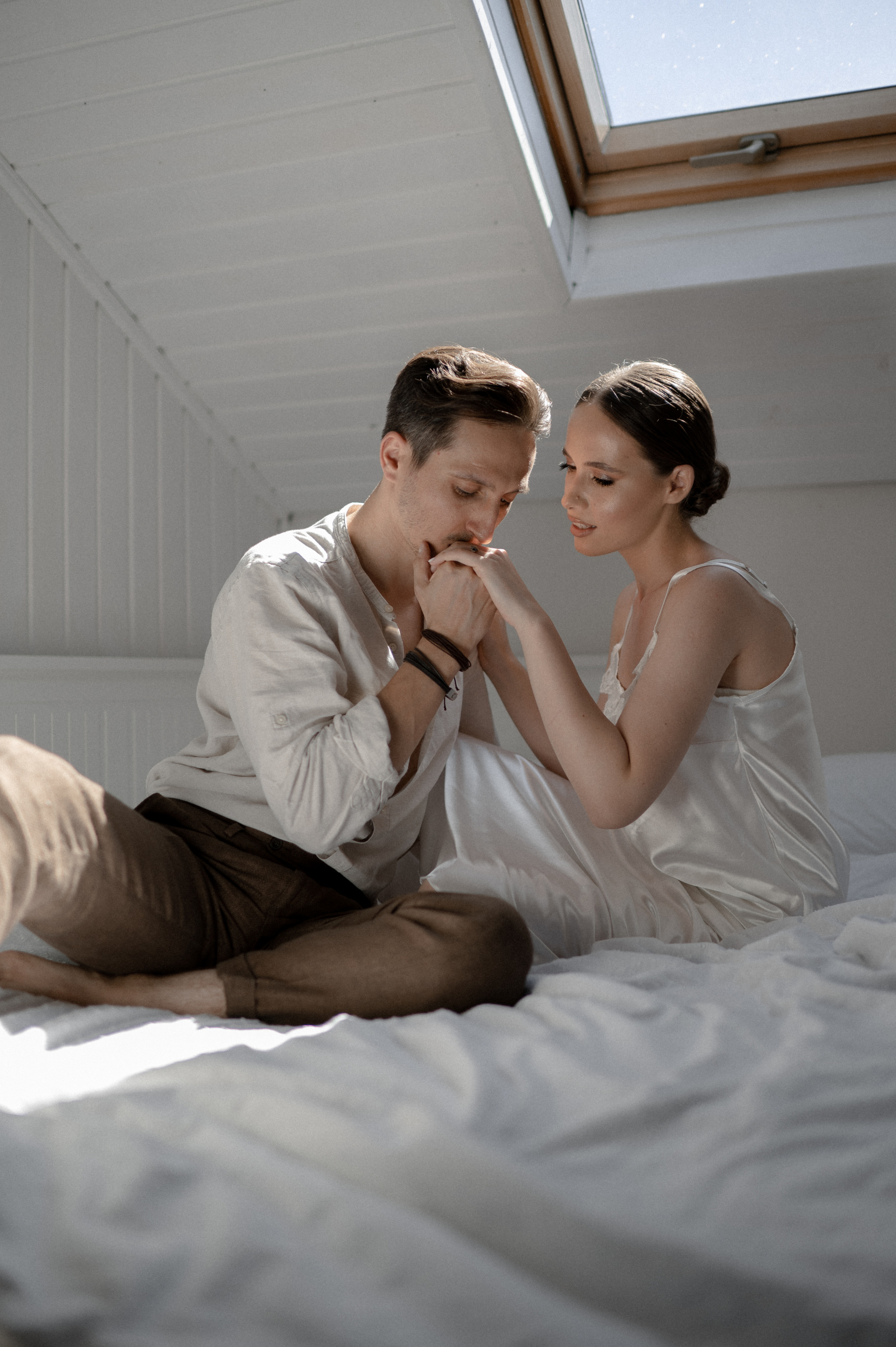 Intimate wedding morning captured as the couple enjoys cozy moments in bed together, sharing love and anticipation for their special day - a romantic start to their journey as a newly married couple.