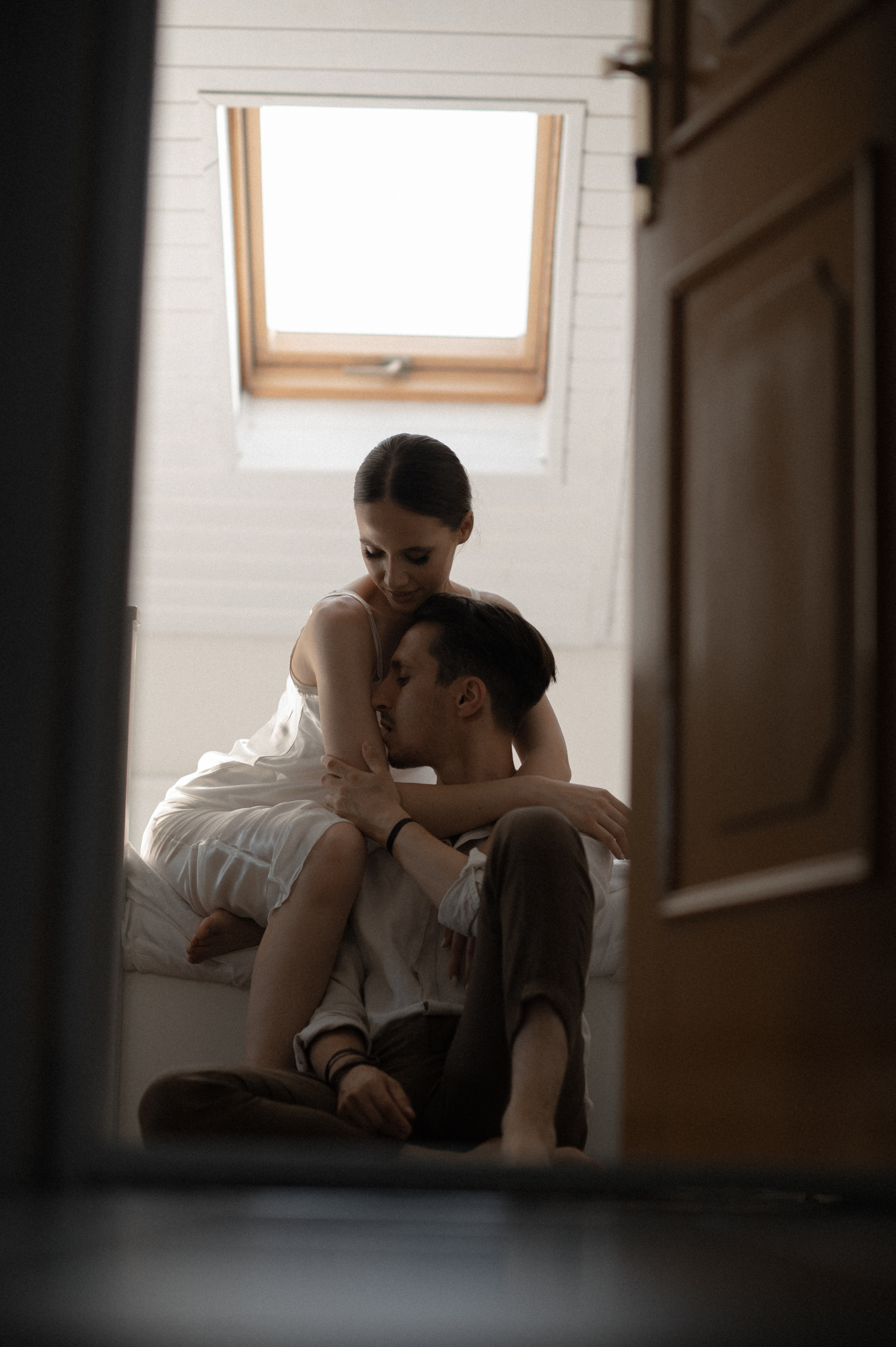 A tender start to their wedding day, the couple revels in affectionate moments in bed, basking in love and anticipation.